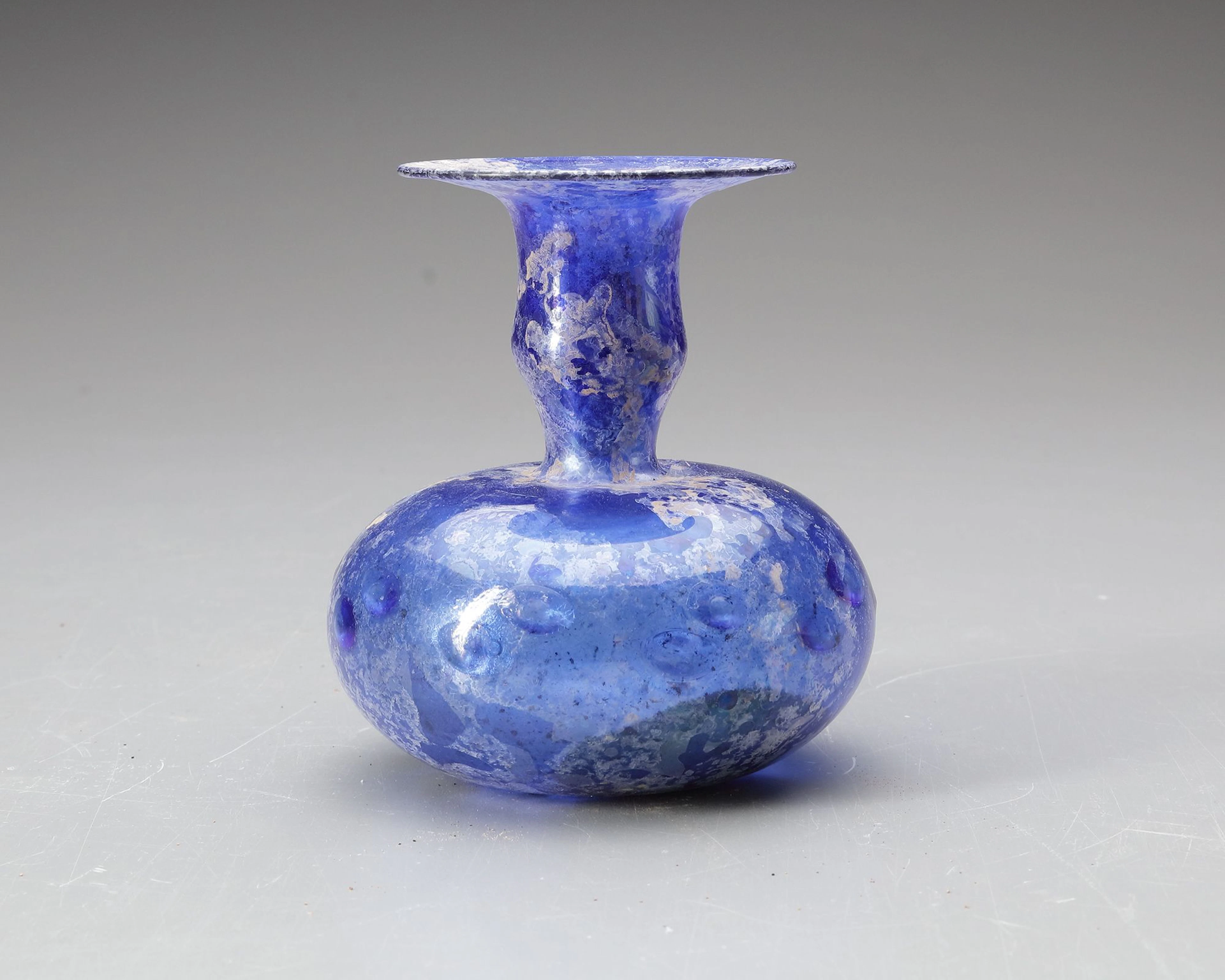 A BLUE GLASS BOTTLE, PERSIA OR SYRIA, 11TH–12TH CENTURY