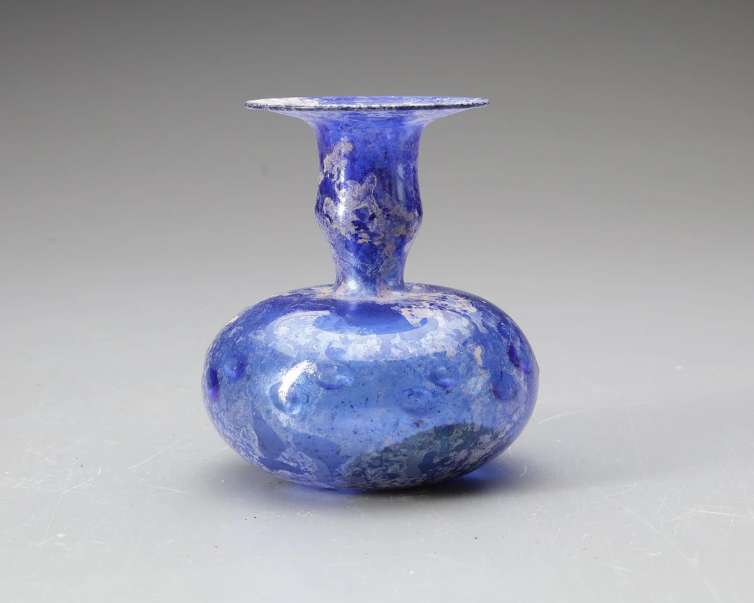 A BLUE GLASS BOTTLE, PERSIA OR SYRIA, 11TH–12TH CENTURY