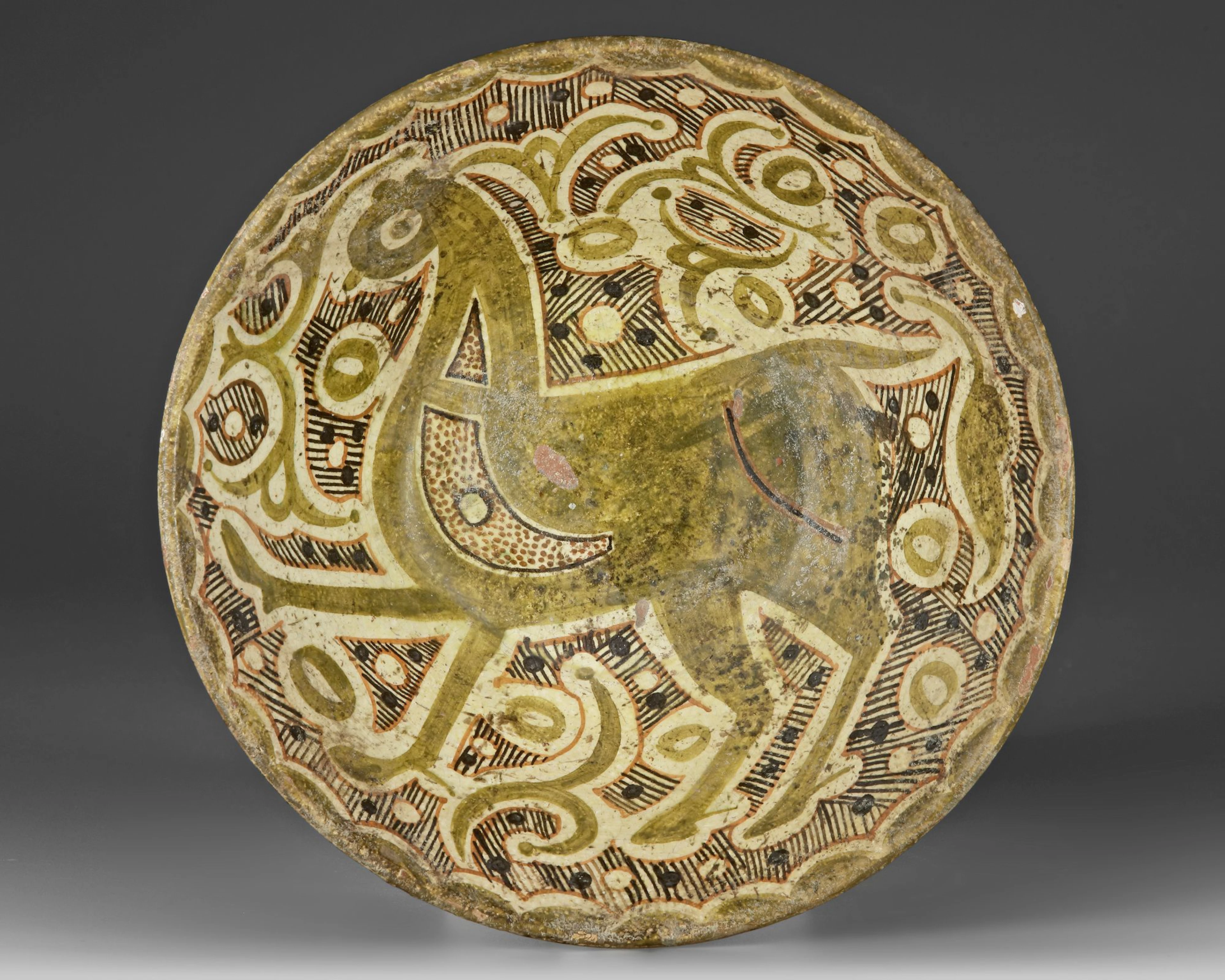 A NISHAPUR SLIP-PAINTED POTTERY BOWL, PERSIA, 10TH-11TH CENTURY