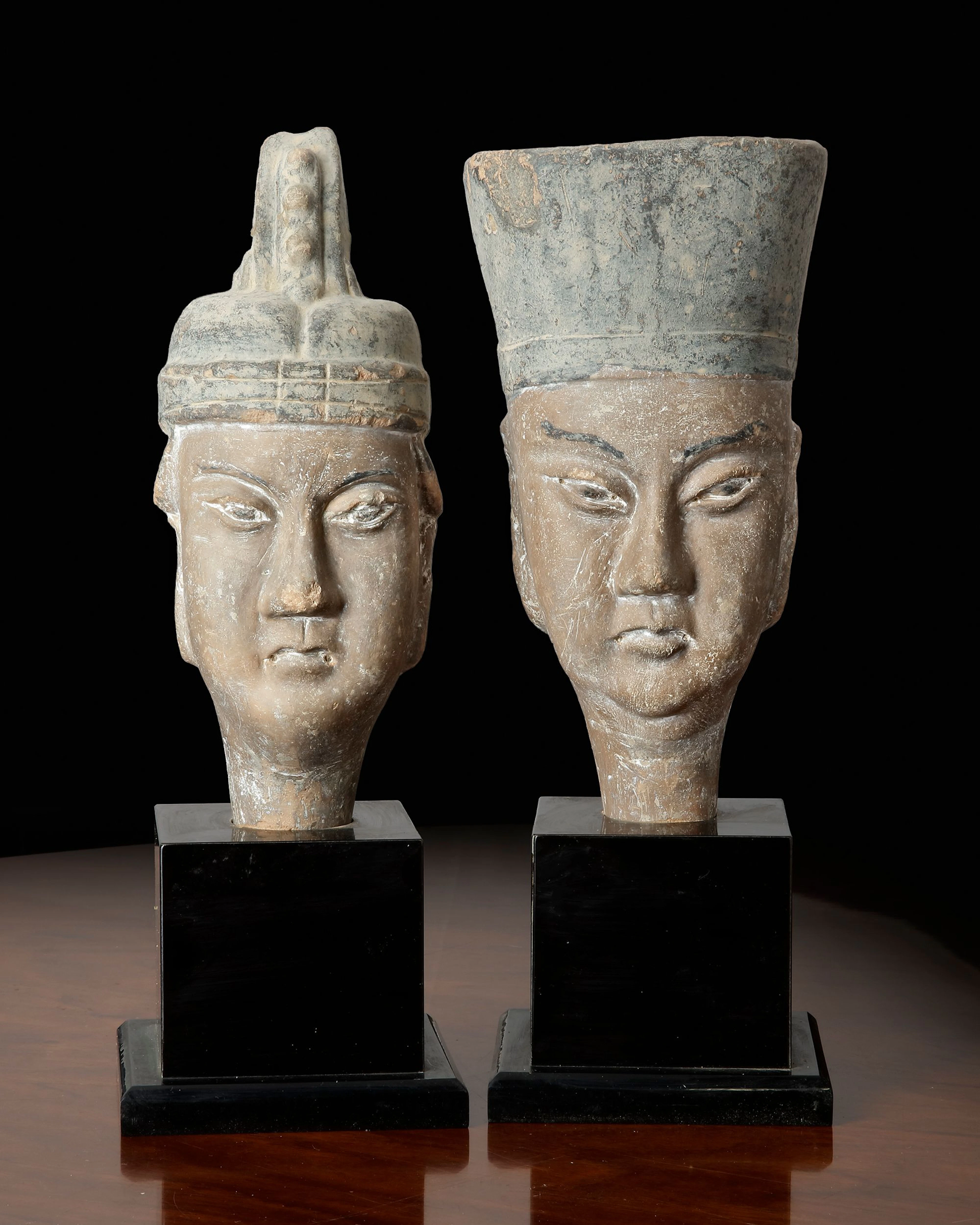 A PAIR OF CHINESE TERRACOTTA HEADS OF A MAN AND WOMAN, MING DYNASTY (1368–1644)