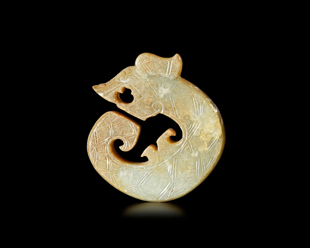 A YELLOWISH-GREEN JADE DRAGON, CHINA, SHANG DYNASTY