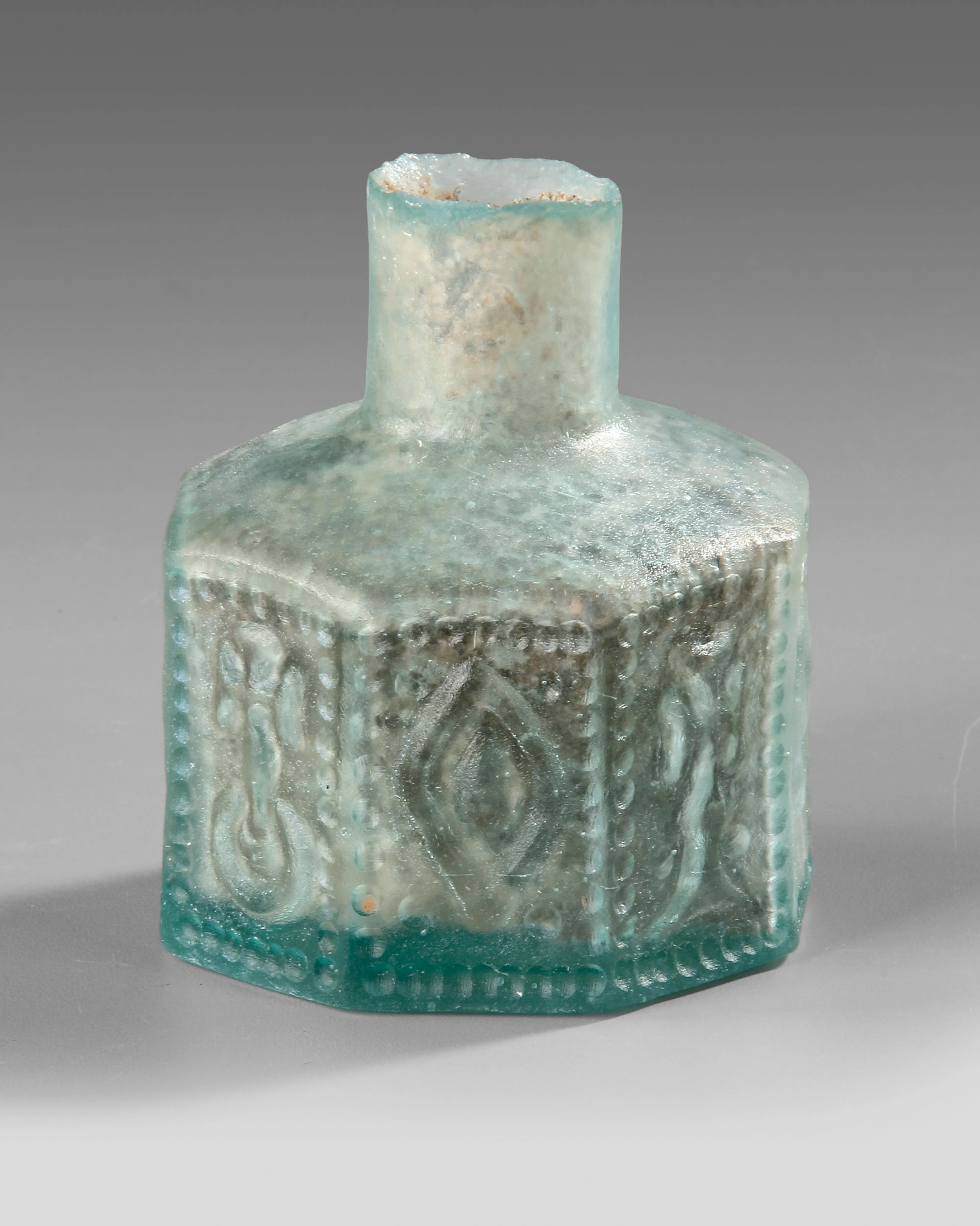 A MOLDED HEXAGONAL GLASS BOTTLE, 7TH–9TH CENTURY