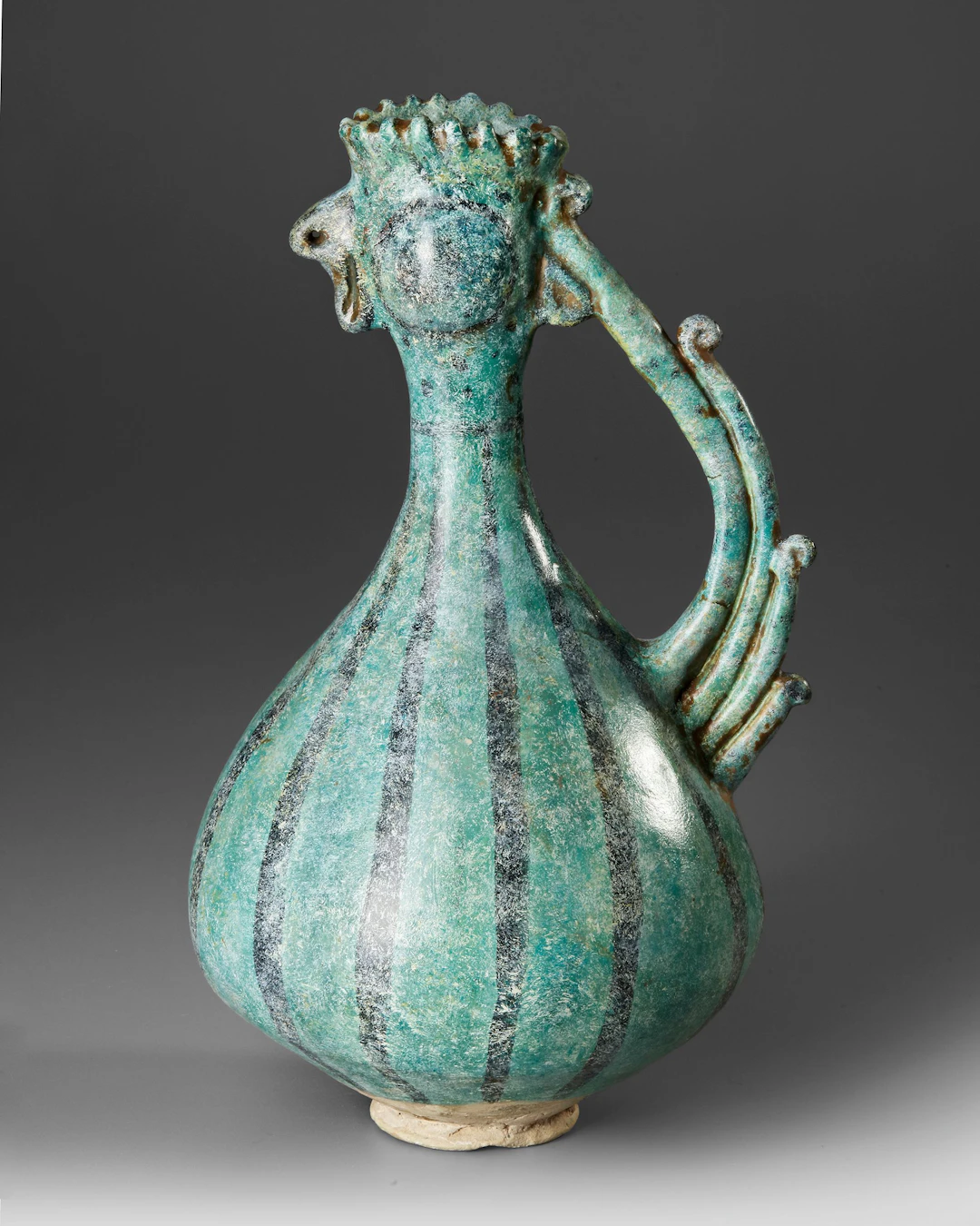 A KASHAN TURQUOISE GLAZED COCKEREL-HEAD POTTERY EWER, PERSIA, 13TH CENTURY