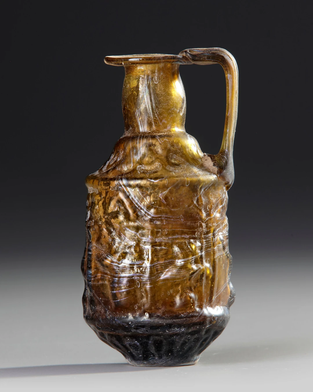 A SIDONIAN MOLD-BLOWN EWER, SIDON, 1ST CENTURY AD
