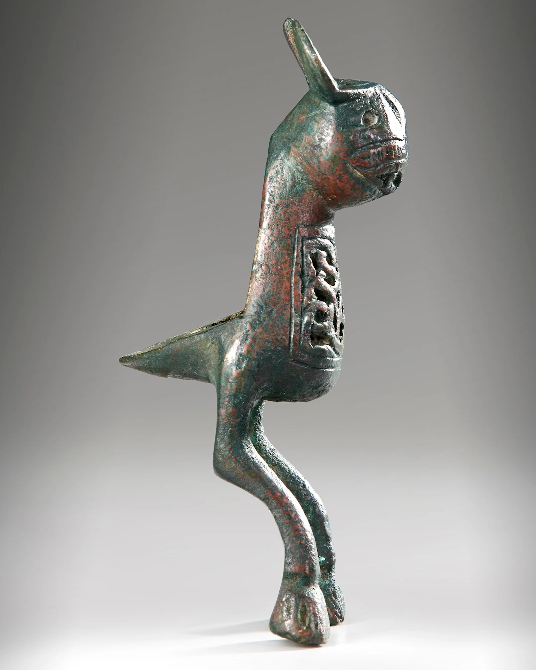 A BRONZE FINIAL IN THE FORM OF HARE, POSSIBLY FATIMID, 11TH-13TH CENTURY