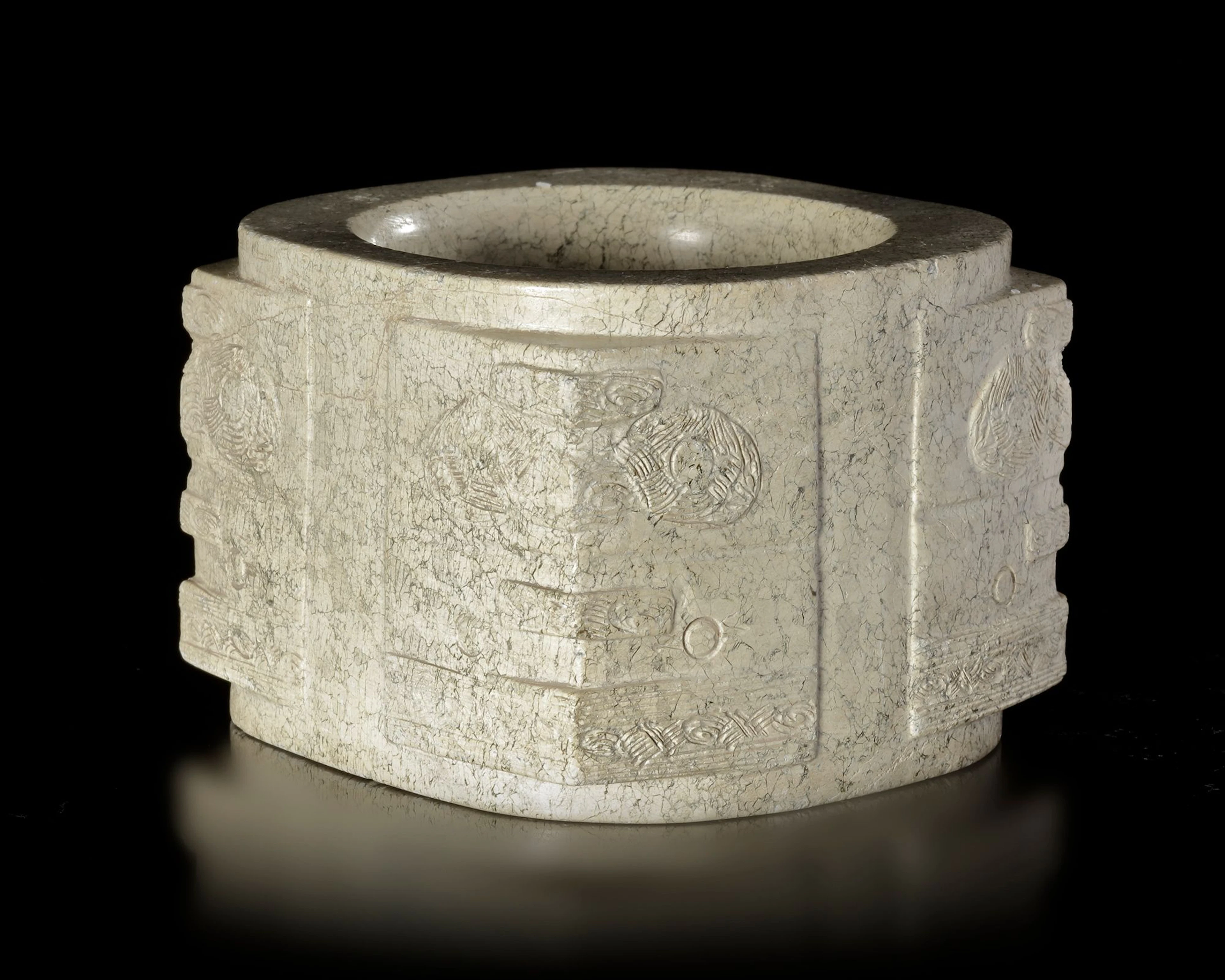 A BEIGE-COLORED JADE CONG WITH RUST-LIKE BROWN INCLUSIONS DECORATED