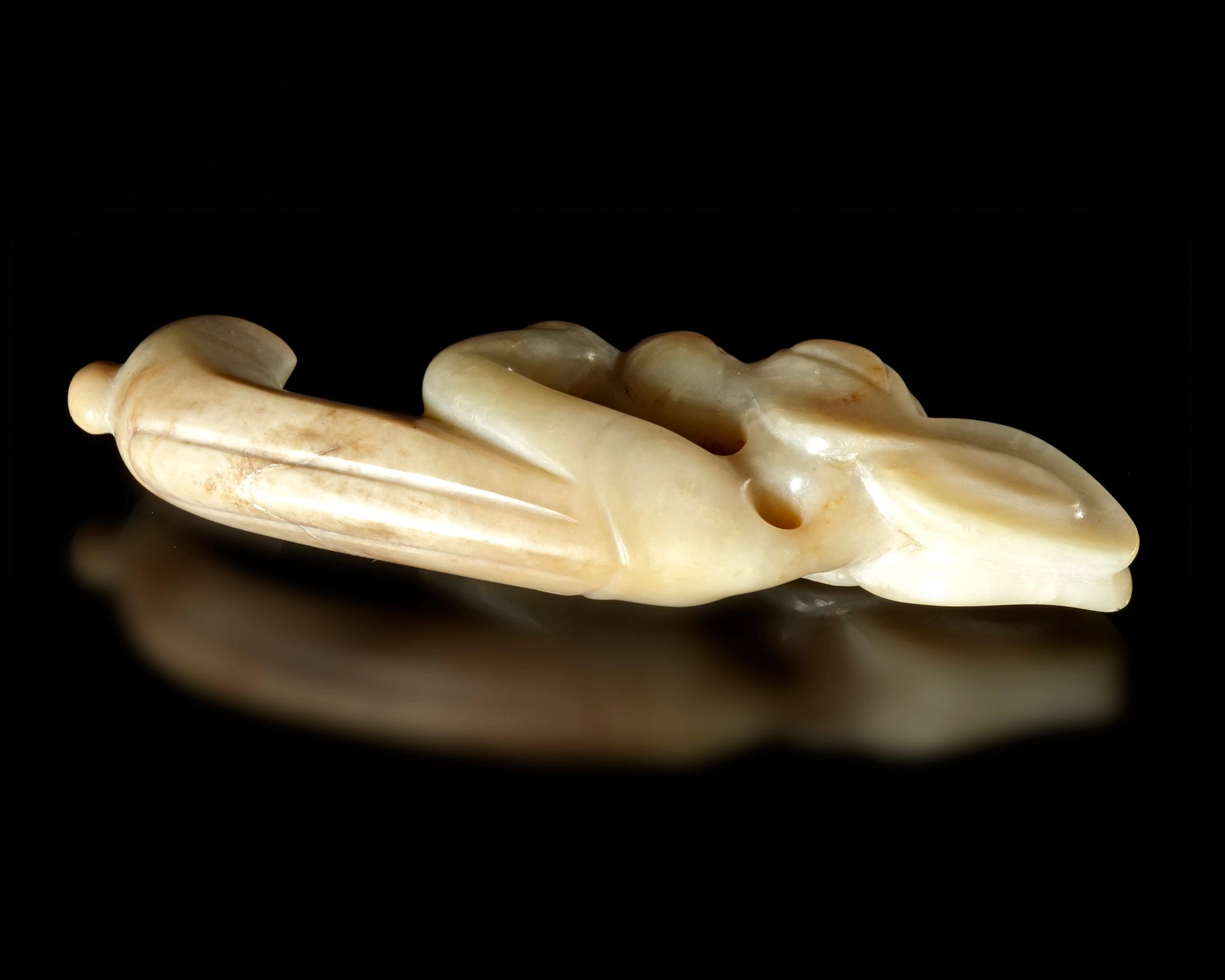 A CREAMY WHITE JADE CARVING OF AN EMBRYONIC MYTHICAL ANIMAL, CHINA