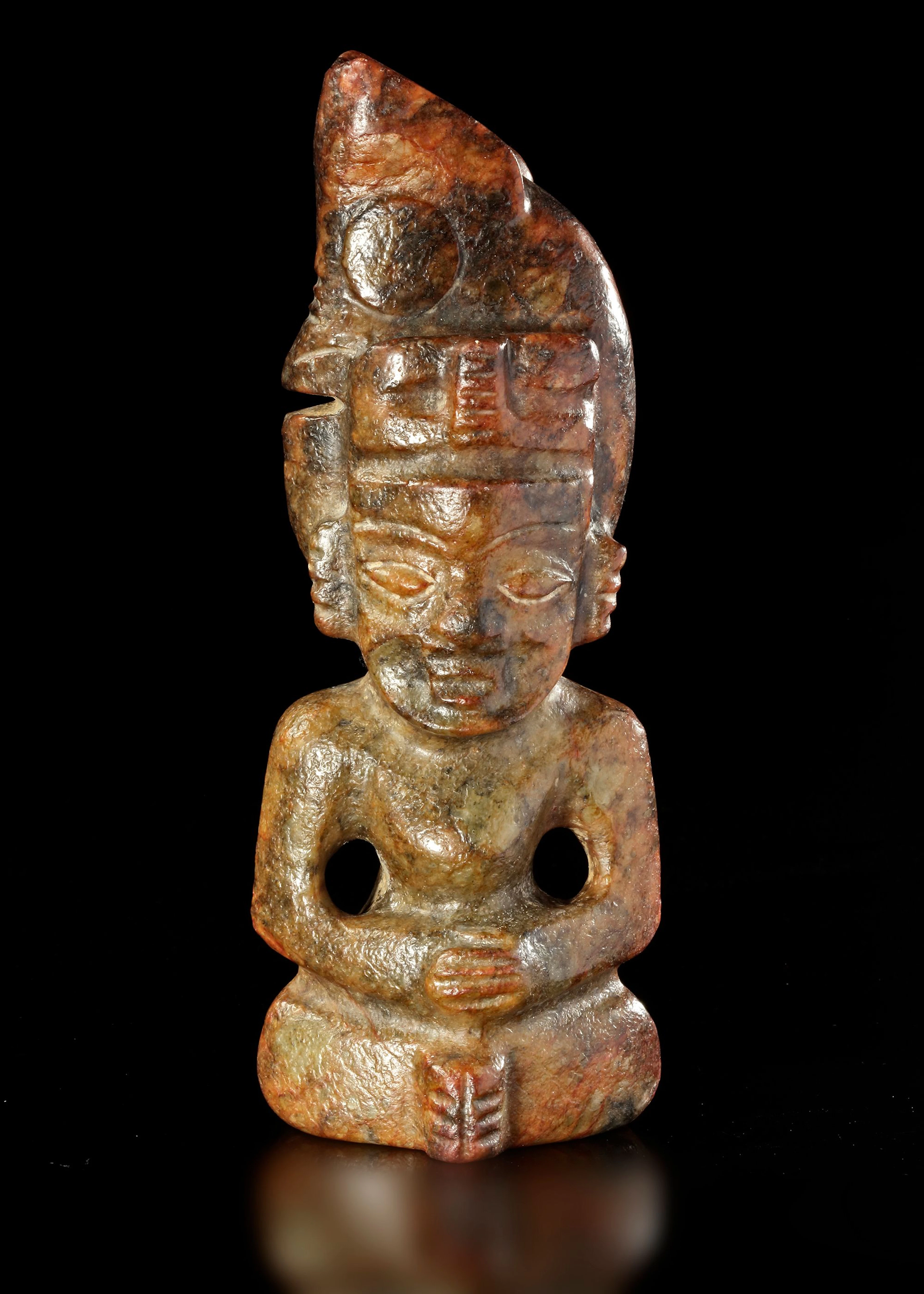A RUSSET JADE SITTING FIGURE WEARING A PIG DRAGON ON IT'S HEAD, CHIN