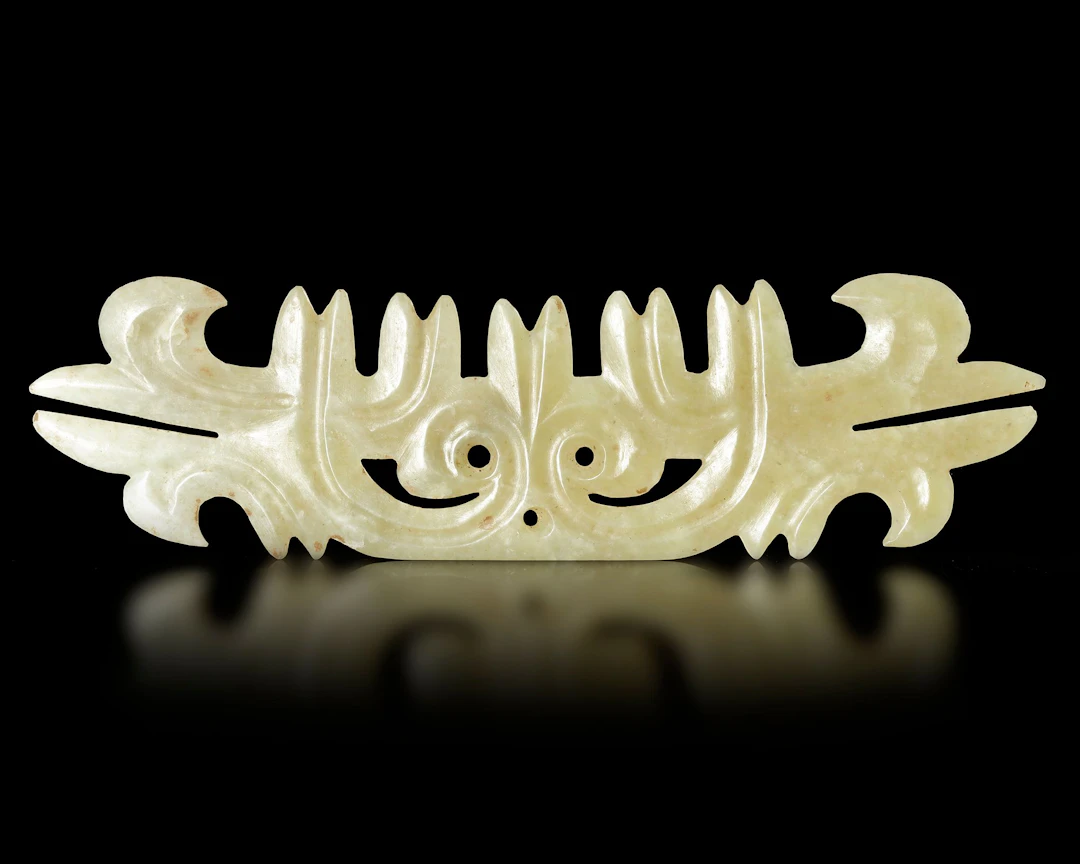 A TOOTHED ANIMAL MASK OF LIGHT GREEN JADE, 'GOU YUN PEI', CHINA, HONGSHAN