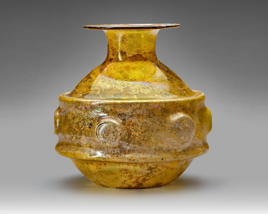 AN AMBER GLASS VESSEL, PERSIA OR SYRIA, 11TH–12TH CENTURY