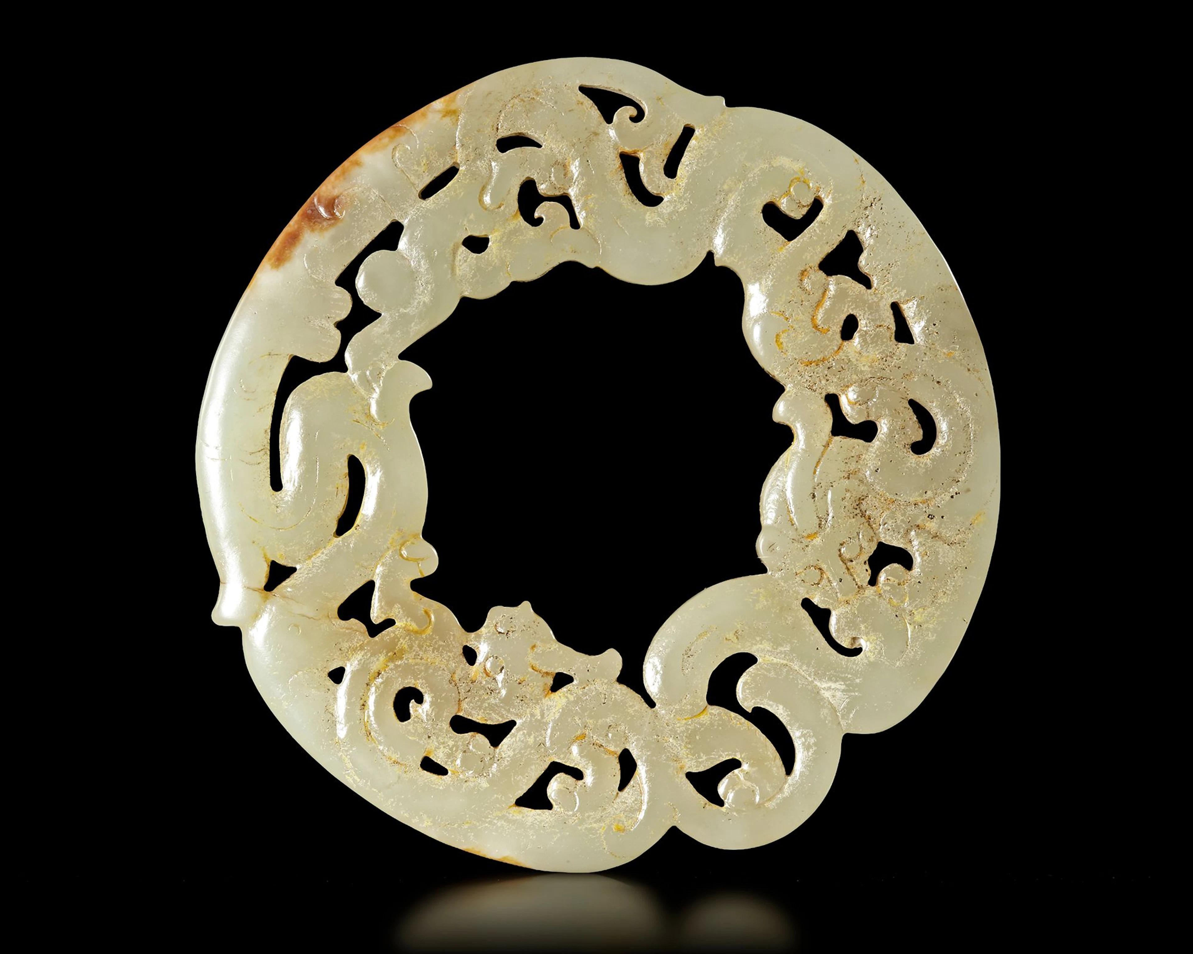 A WHITE JADE DRAGON/PHOENIX RING, HUAN, CHINA, HAN DYNASTY (206 BC-220 AD)