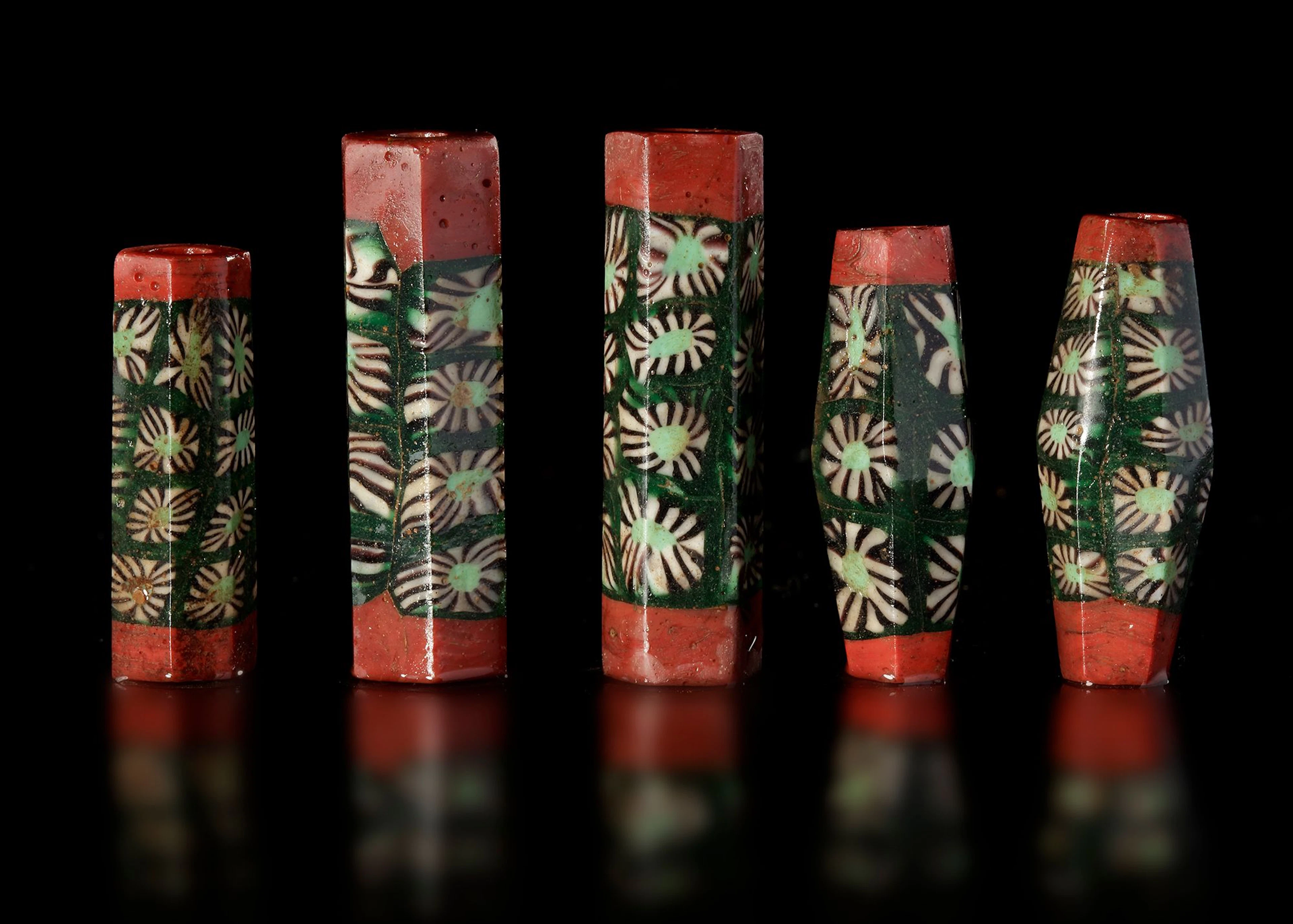 FIVE EARLY ISLAMIC GLASS BEADS SYRIA, 900–1200 AD