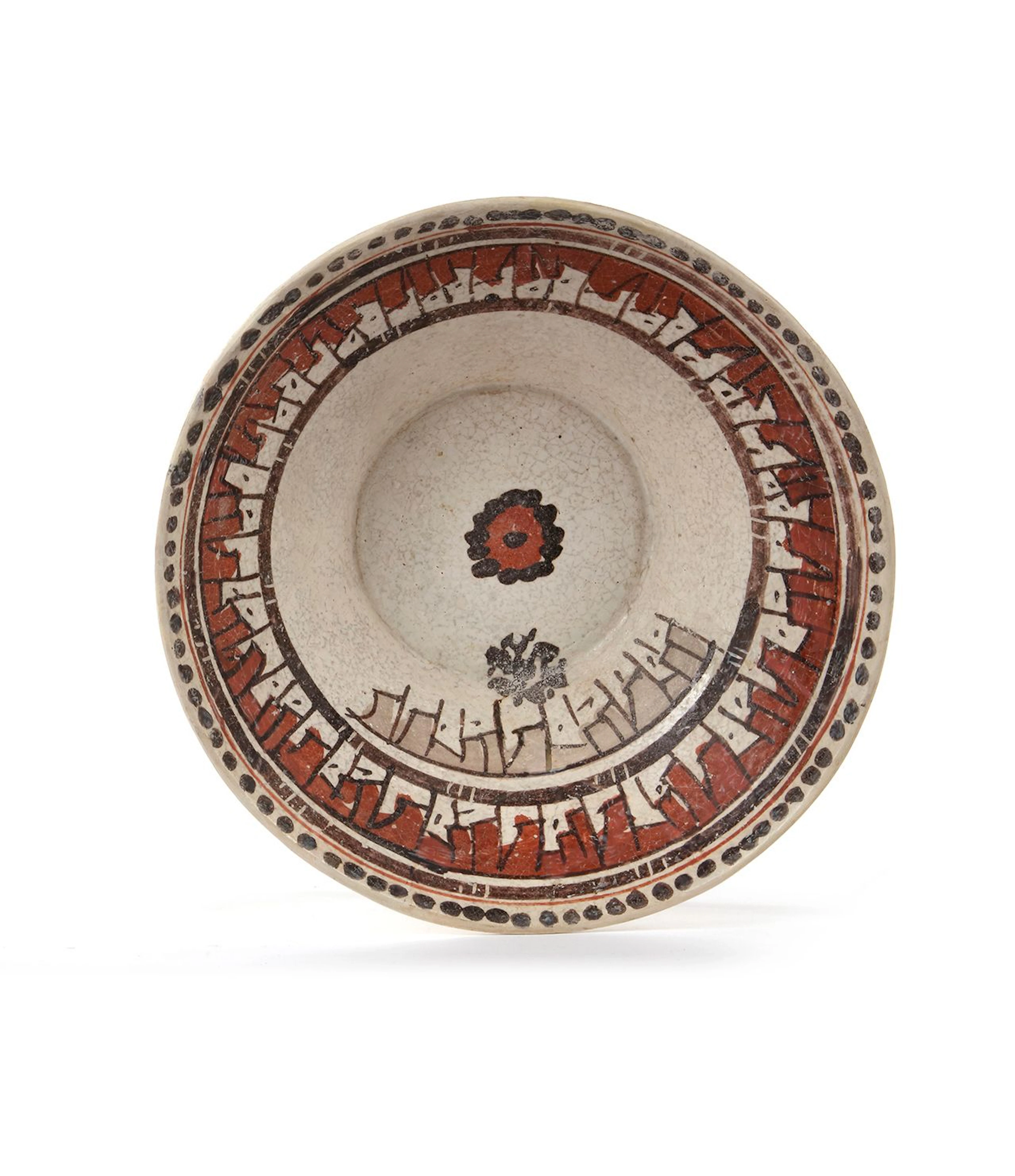 A NISHAPUR SLIP-PAINTED POTTERY BOWL, 9TH-10TH CENTURY