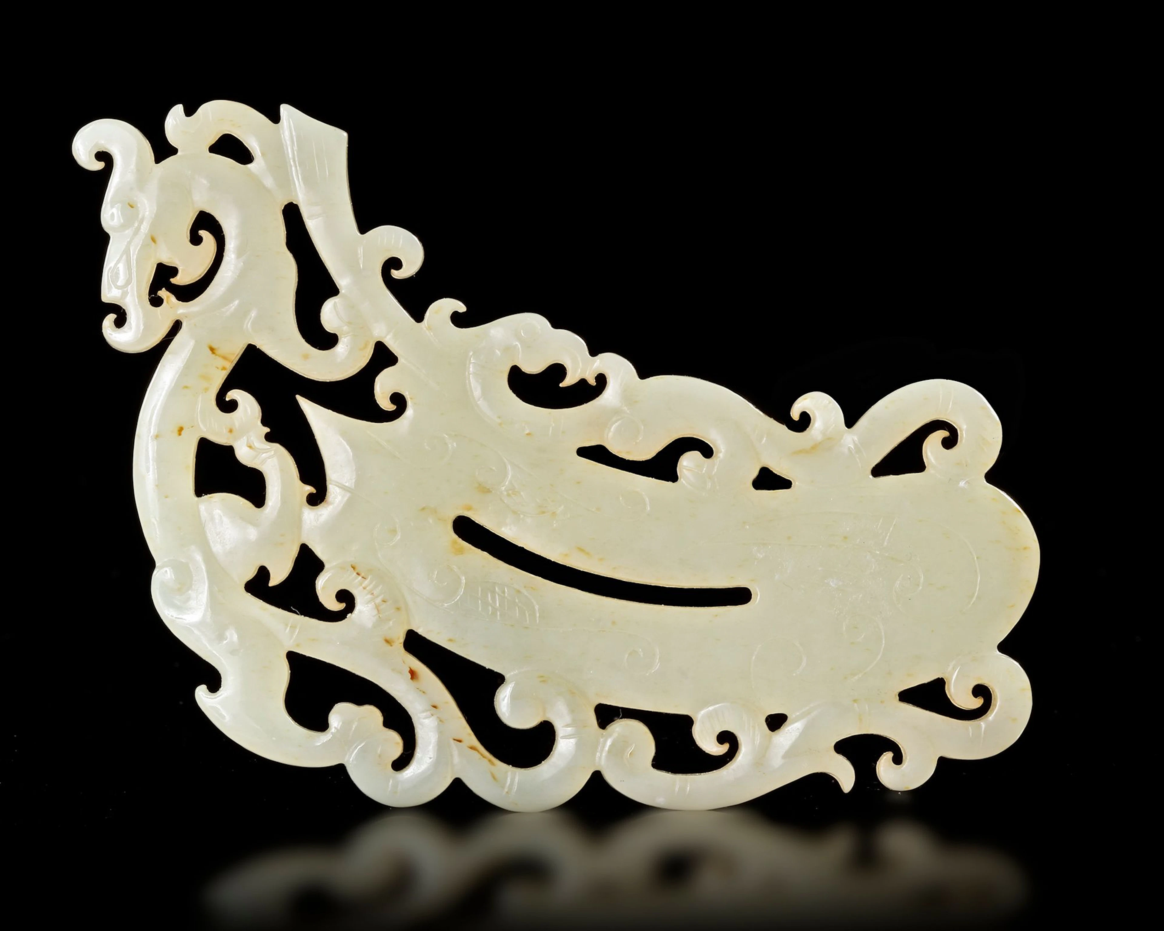 A WHITE JADE SHIELD-SHAPED PENDANT, HAN DYNASTY (206 BC–220 AD)