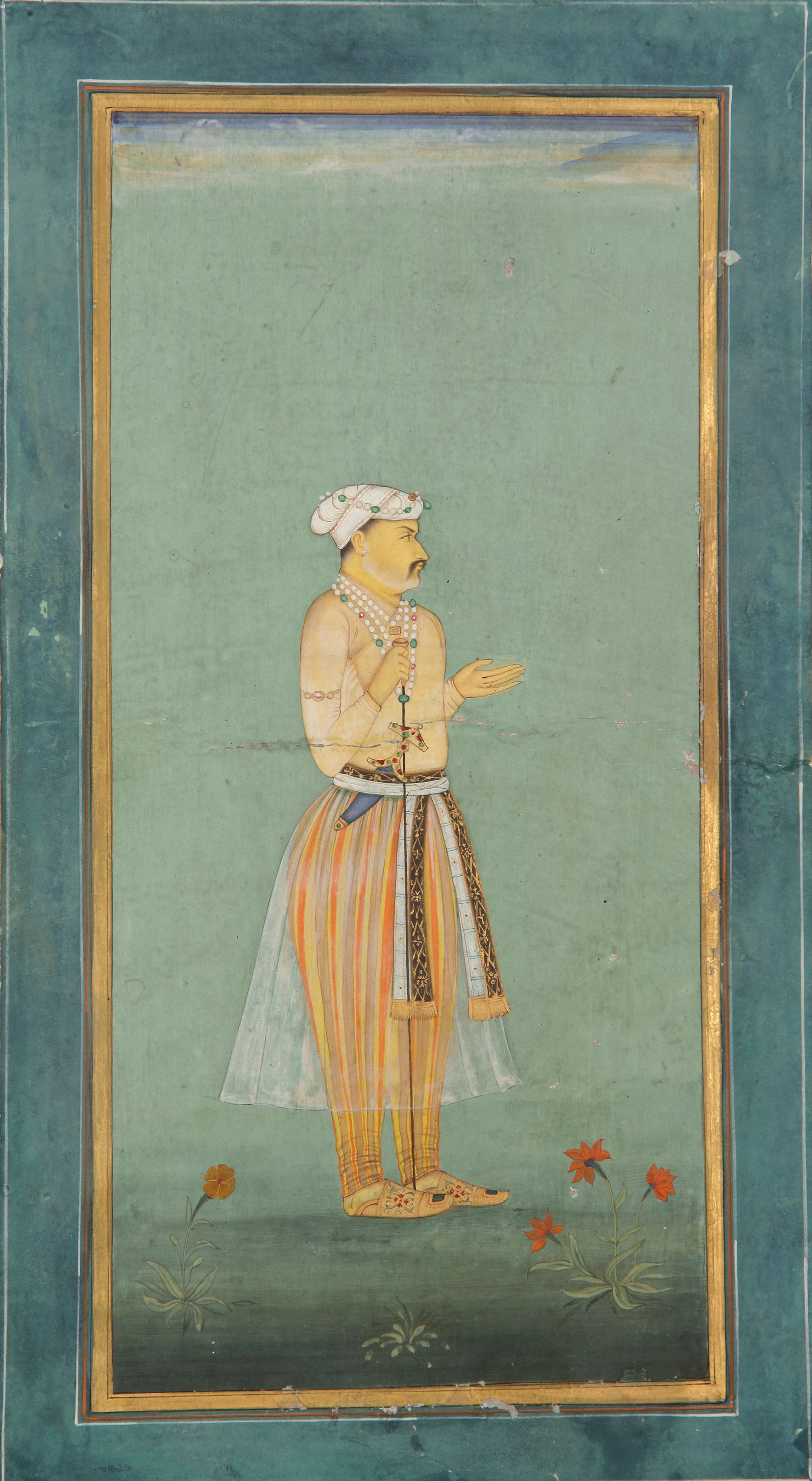 A STANDING PORTRAIT OF A MUGHAL NOBLE, GOUACHE HEIGHTENED WITH GOLD