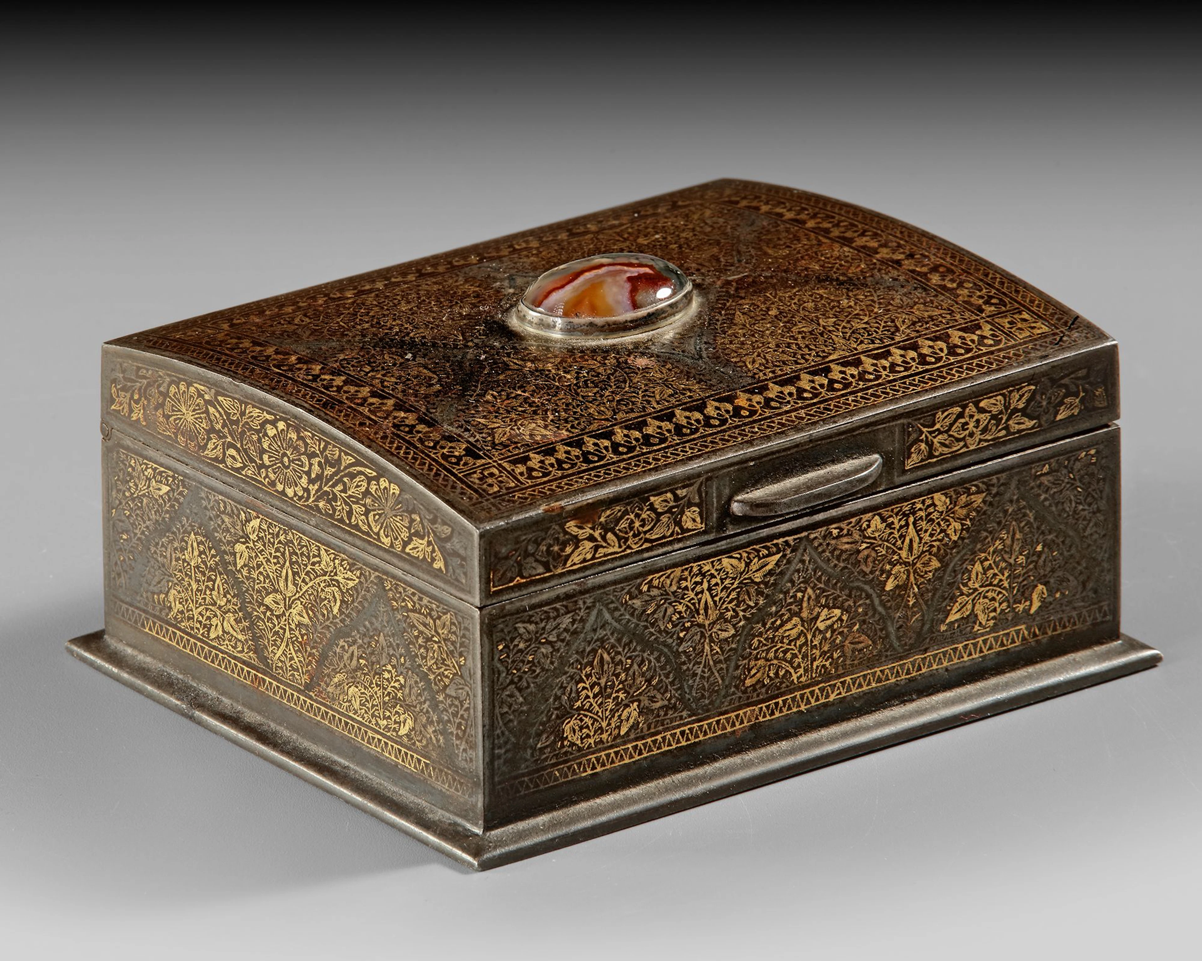 AN INDO-PERSIAN METAL CASKET WITH GILT FLORAL DECORATION AND AGATE