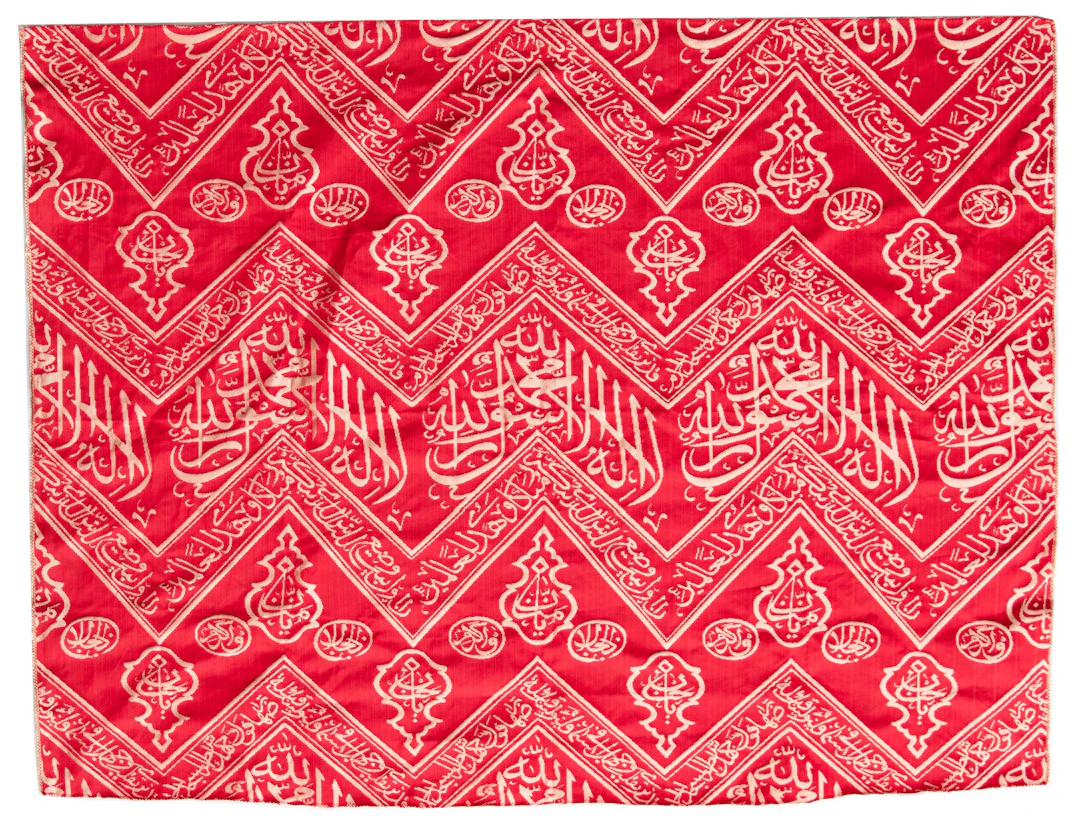 AN OTTOMAN RED EMBROIDERED SILK KISWA FRAGMENT, TURKEY OR EGYPT 20TH CENTURY