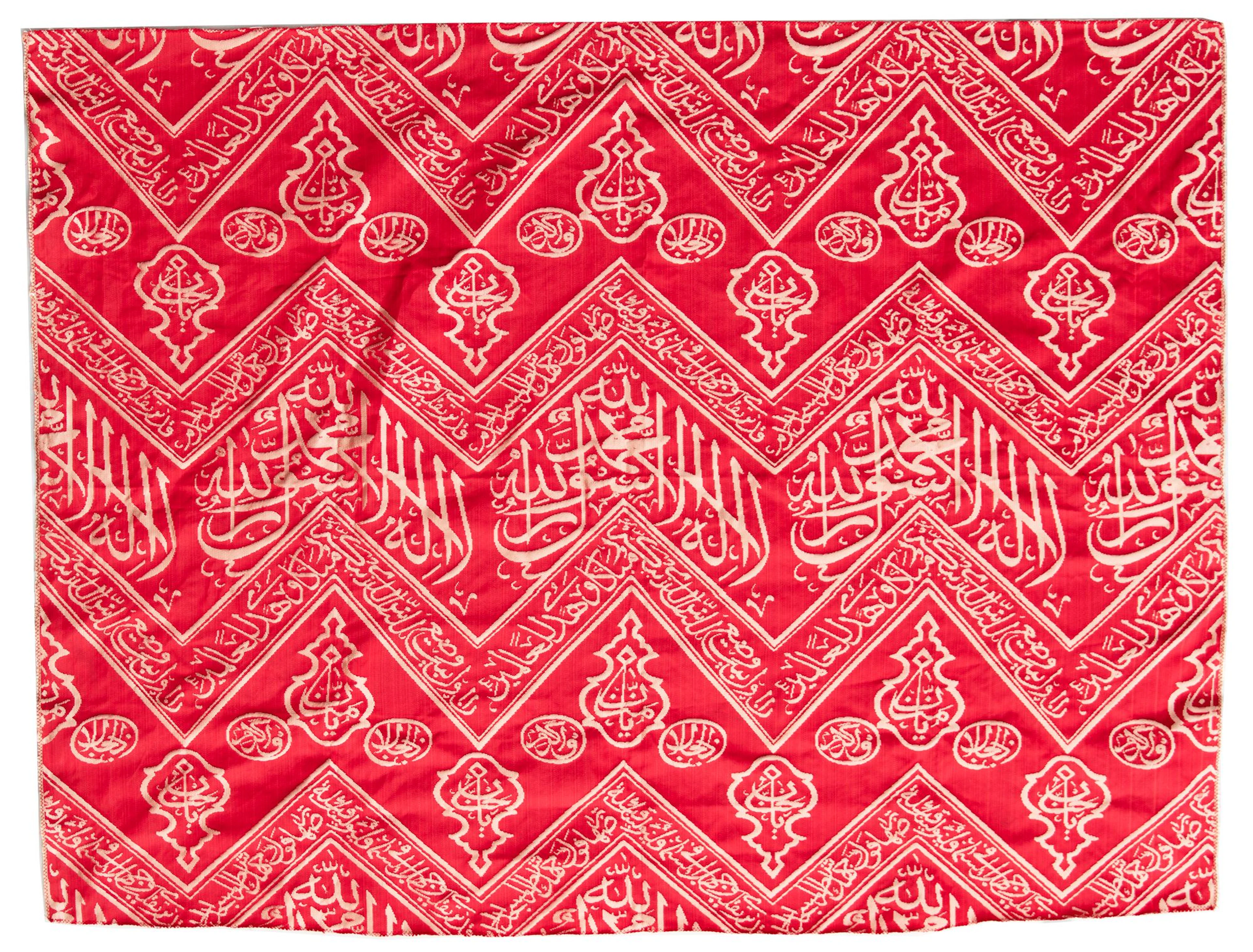 AN OTTOMAN RED EMBROIDERED SILK KISWA FRAGMENT, TURKEY OR EGYPT 20TH CENTURY
