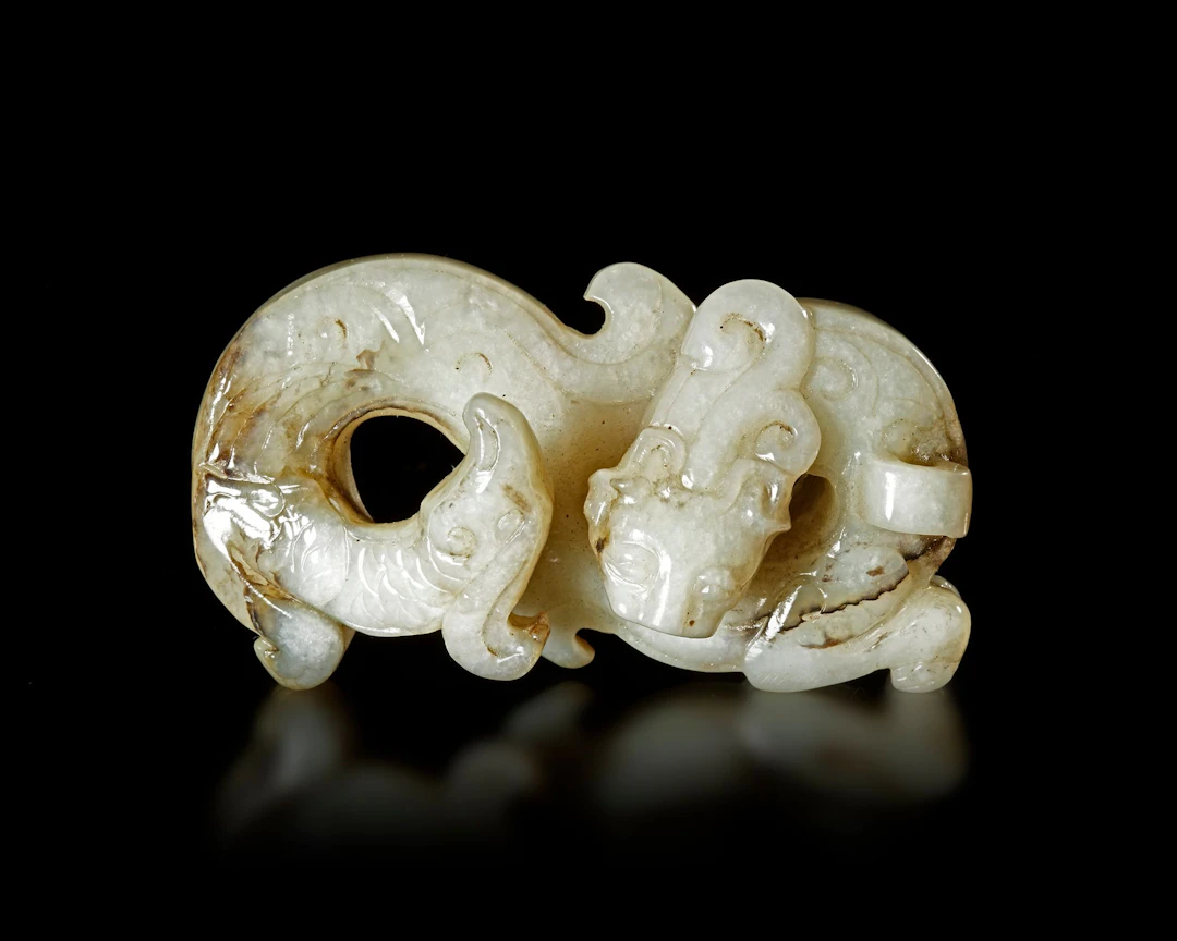 A WHITE JADE DRAGON/PHOENIX PENDANT, CHINA, HAN DYNASTY (206 BC-220 AD)