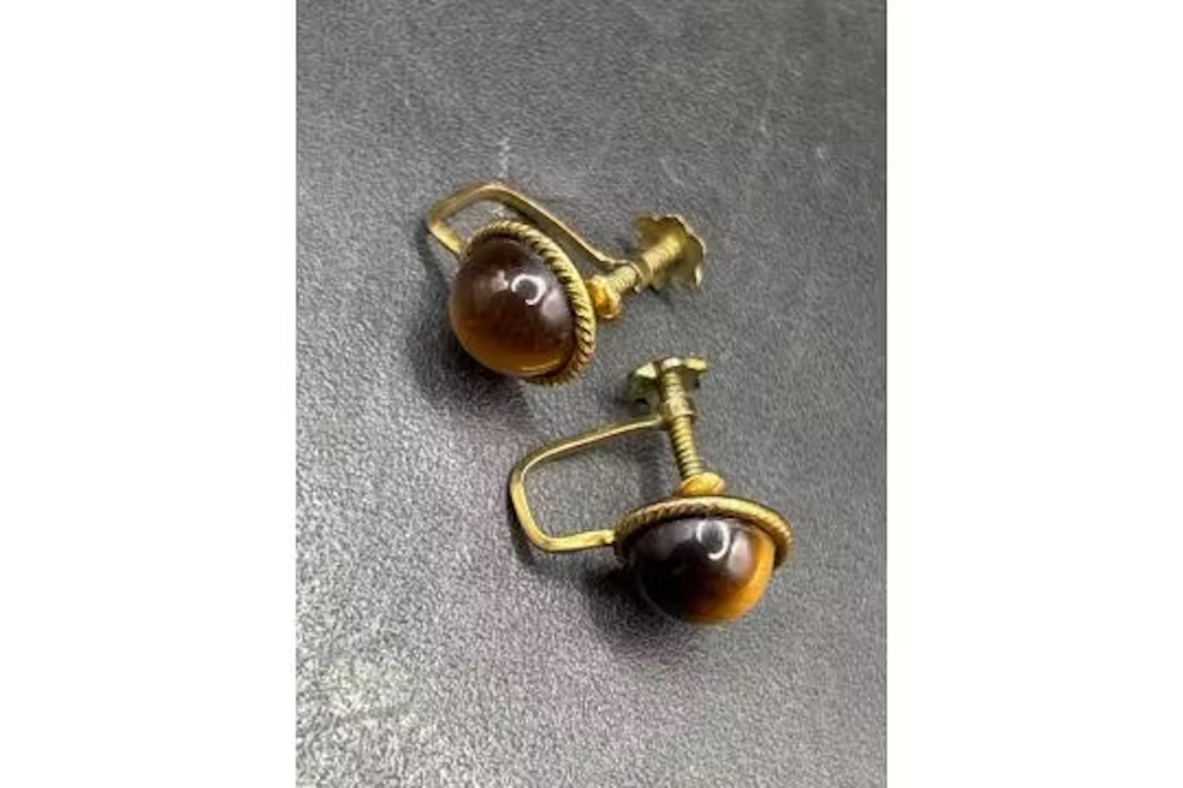 A pretty pair of antique tigers eye gold set earrings with screw fittings