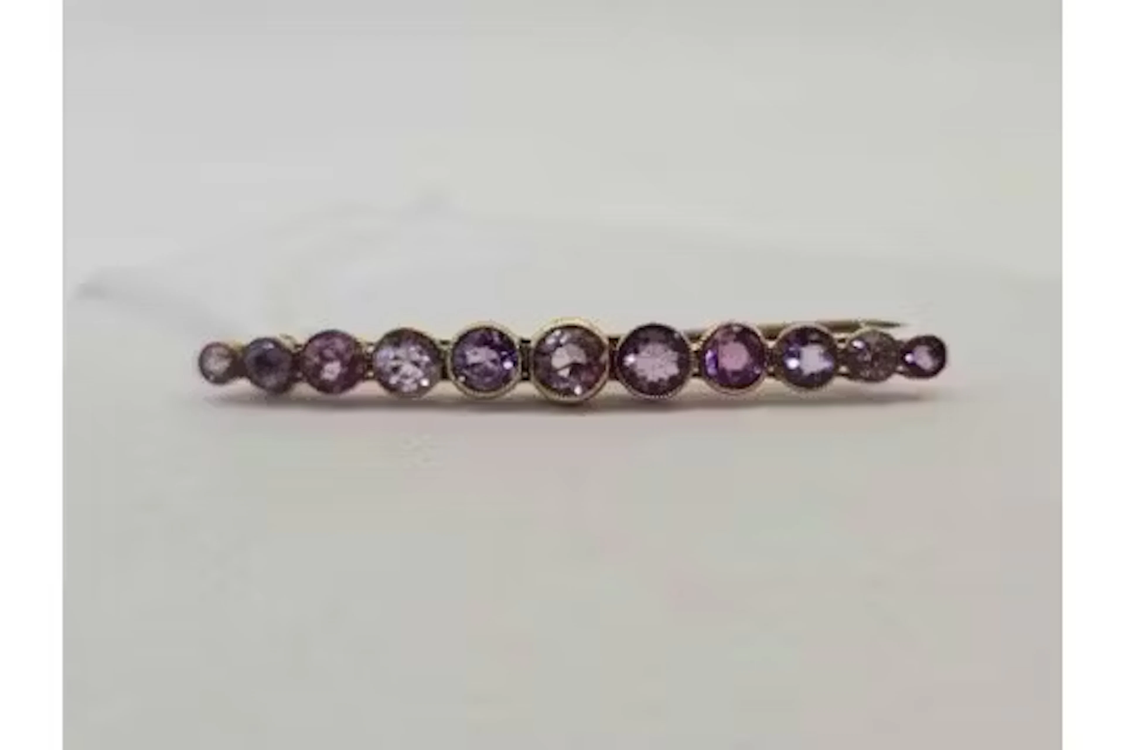 An antique amethyst set bar brooch 9ct 3.3g