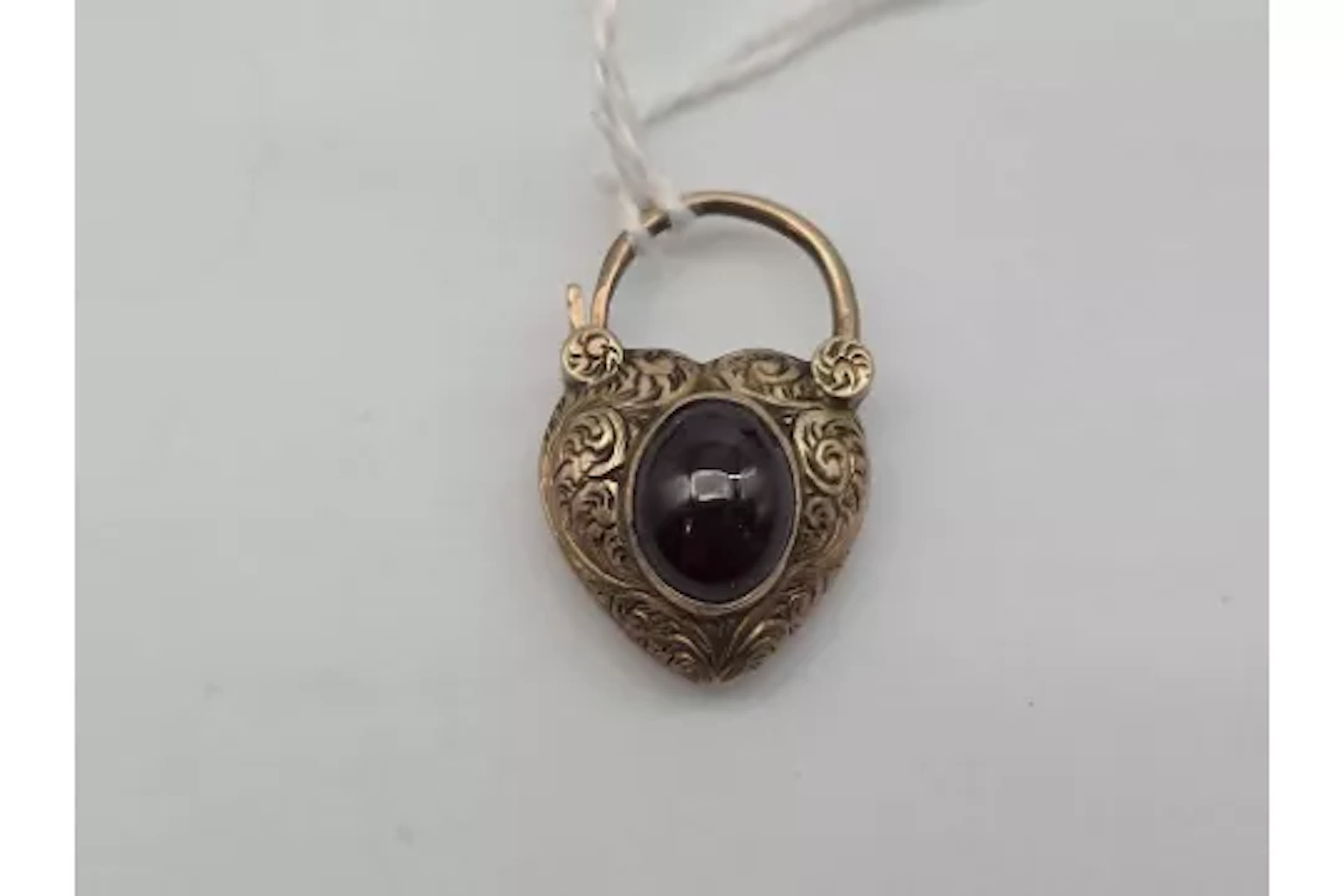 A 19th century gold heart padlock with cabochon garnet 4.3 gms