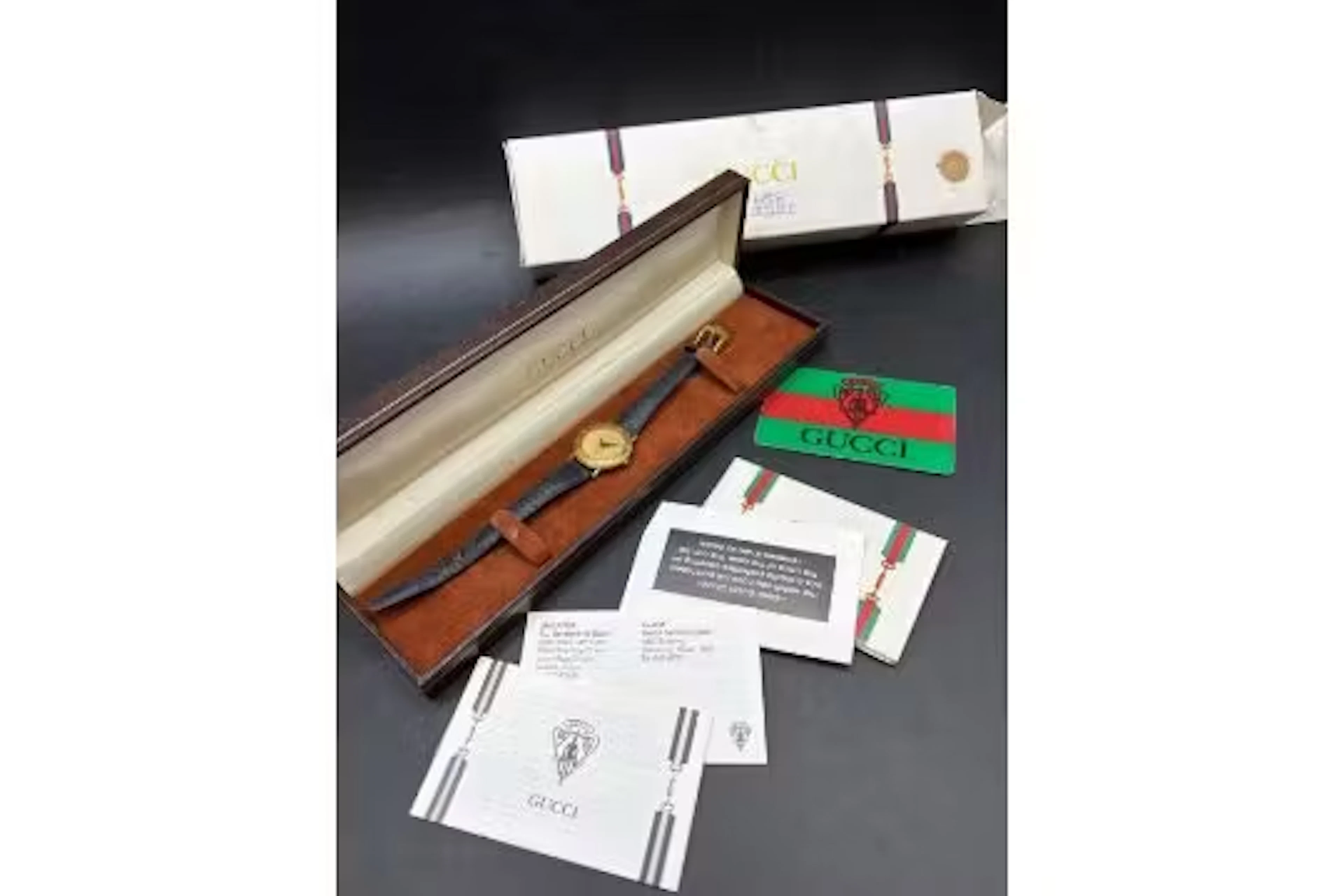 A GUCCI watch with box and packaging