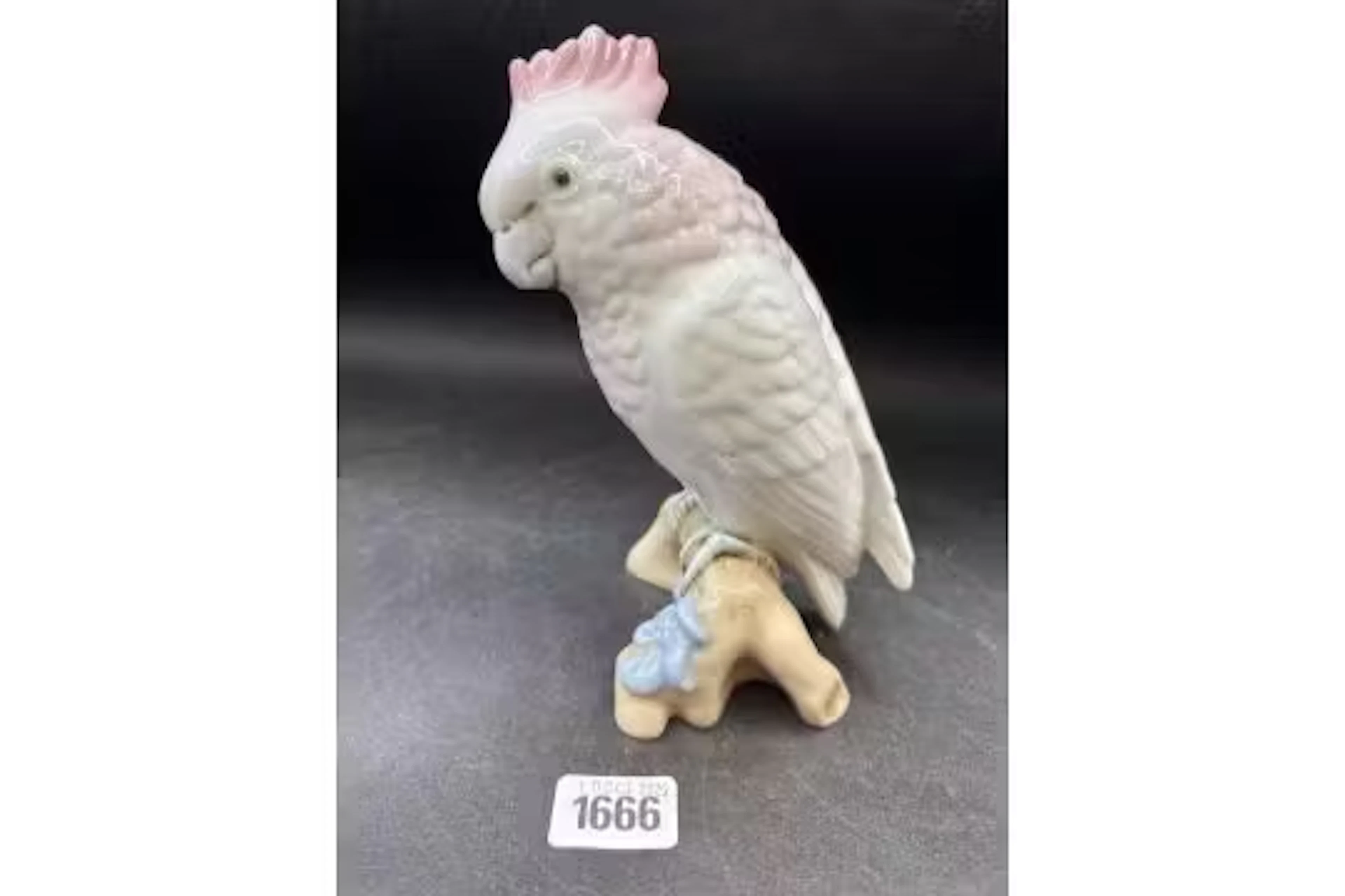 A Royal Dux figure of a parakeet, 7" high