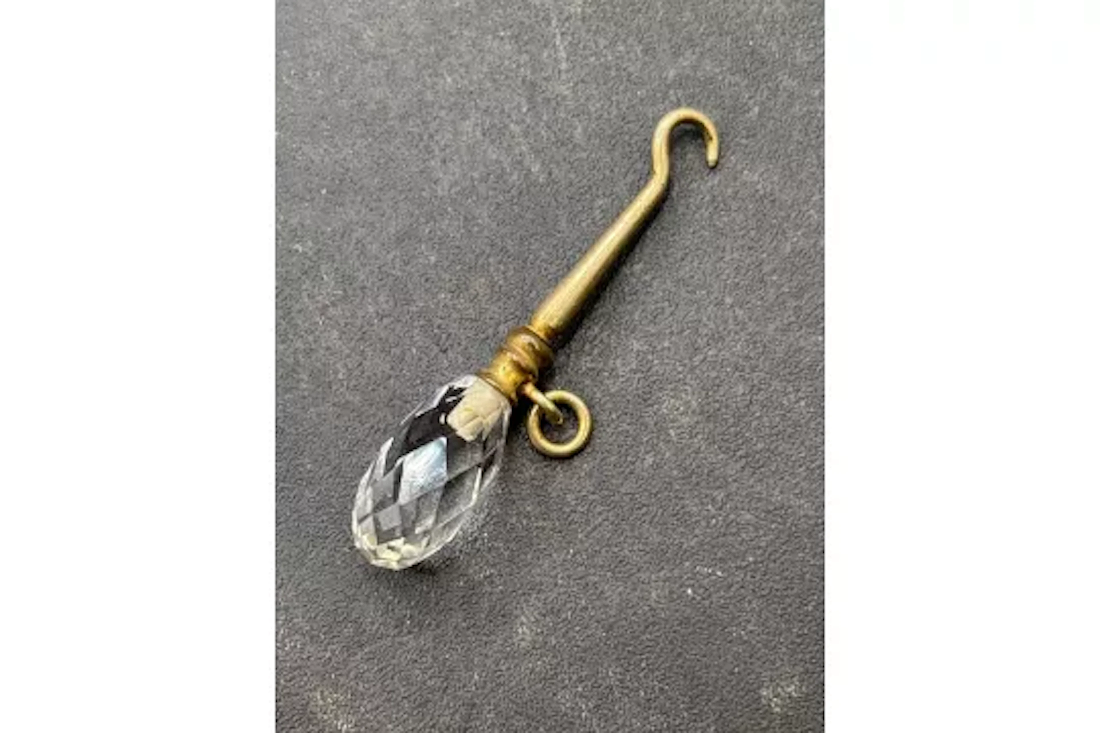 A antique crystal button hook charm