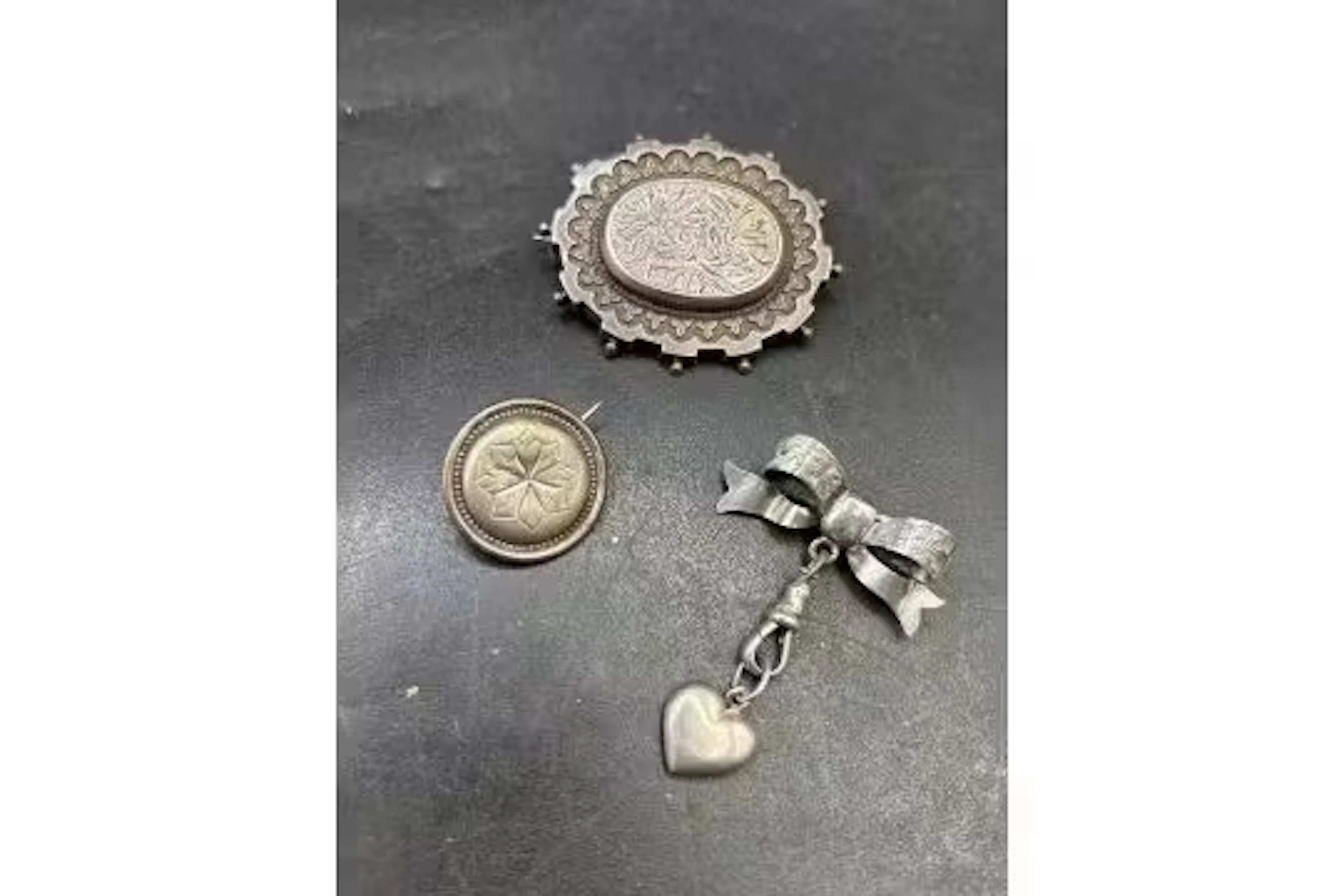 Three antique silver and white metal brooches
