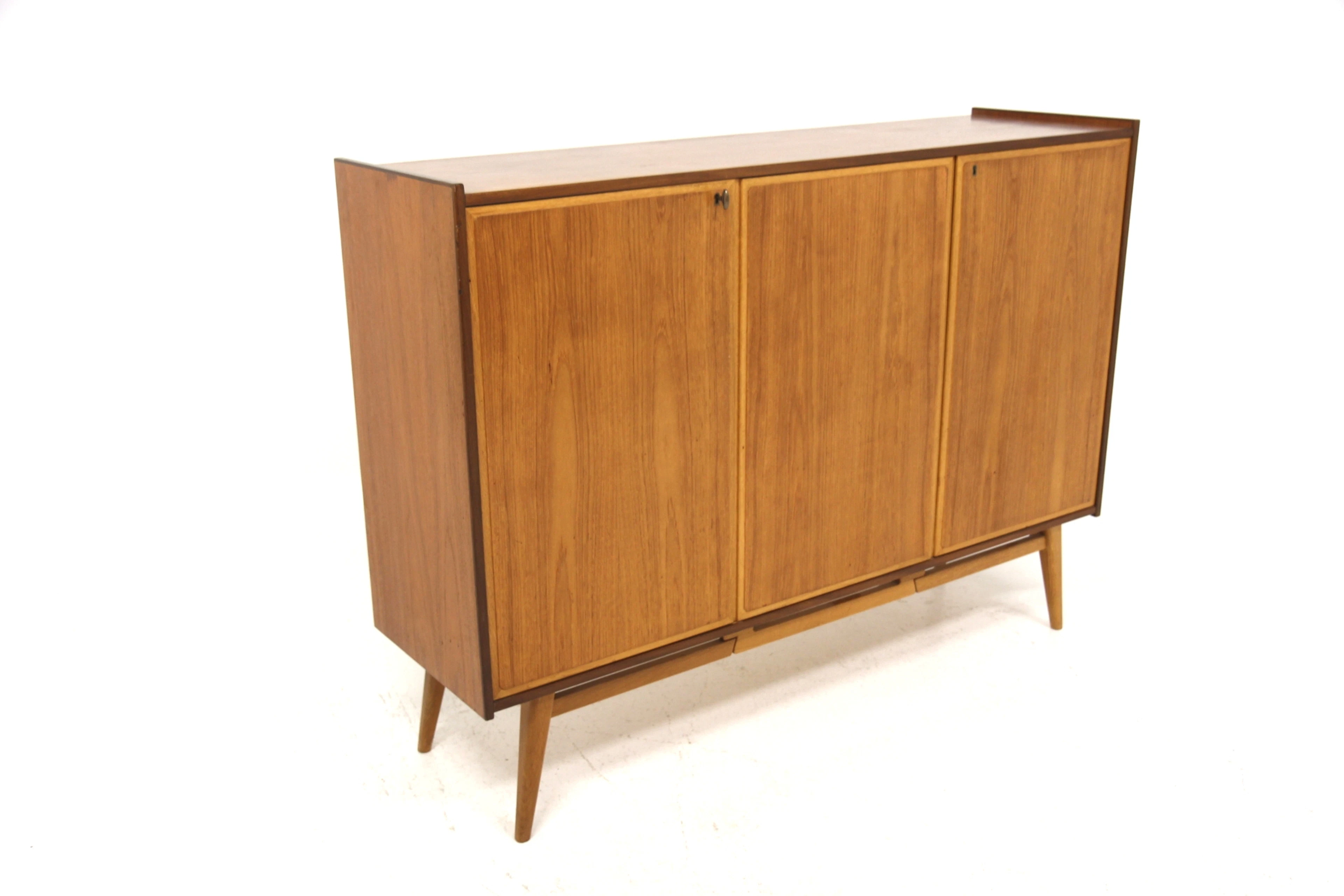 Sideboard / Highboard Year: 1950s Origin: Swe. Material: Teak Oak