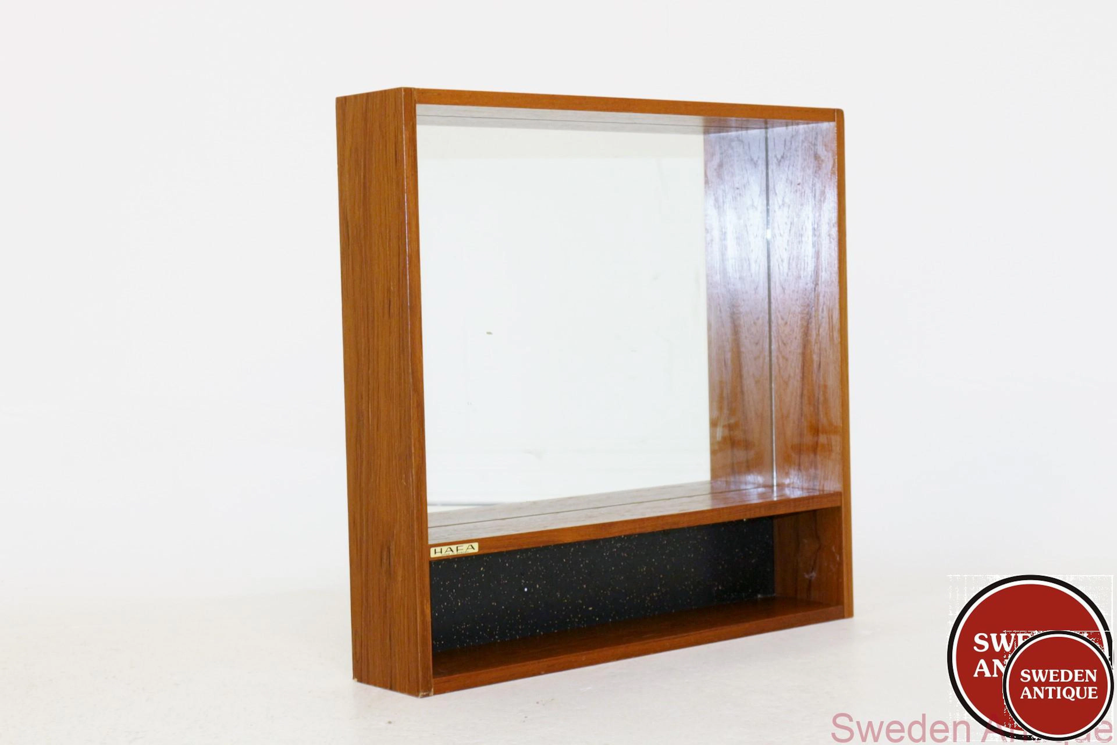 Mirror Year: 1970s Origin: Swe. Material: Teak Glass W: 62,5cm D: 12cm H: 60cm