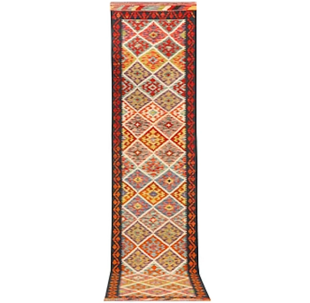 An Afghan kilim runner, c. 403 x 82 cm.
