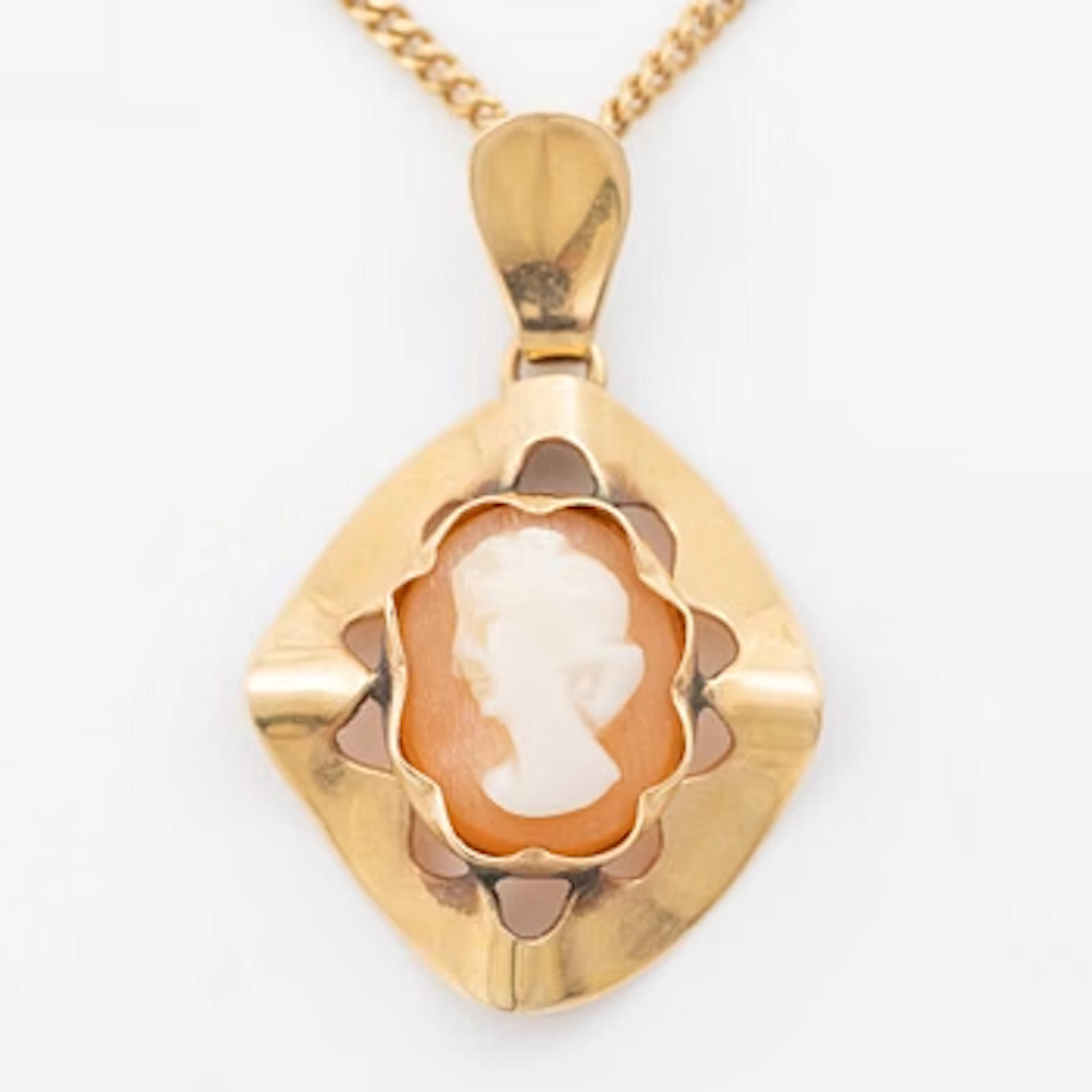 18K gold pendant with a shell cameo and an 18K gold chain.