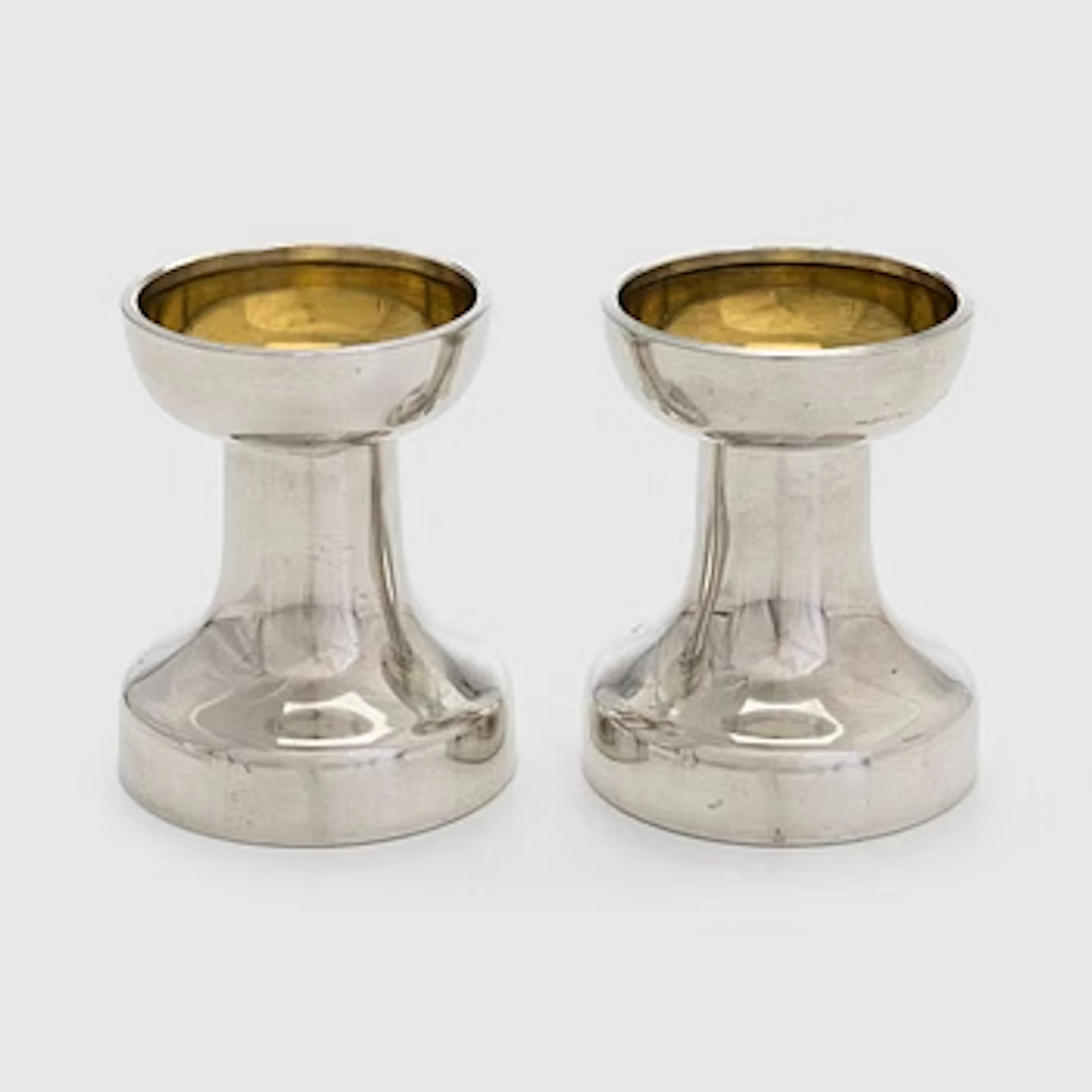 Bertel Gardberg, a pair of candlesticks in pewter and brass for Hopeatehdas