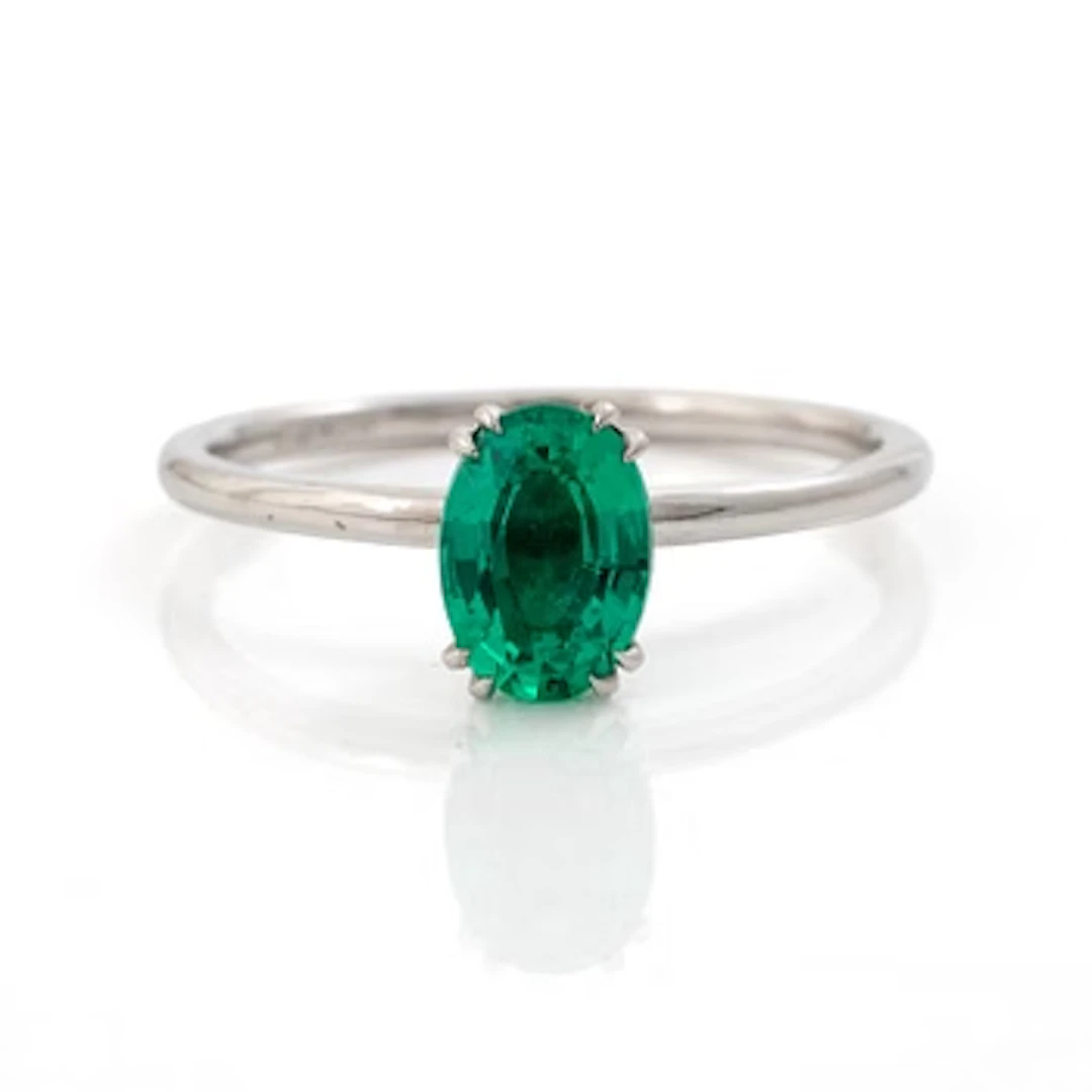 Ring 14K white gold with synthetic emerald and brilliant-cut diamonds.