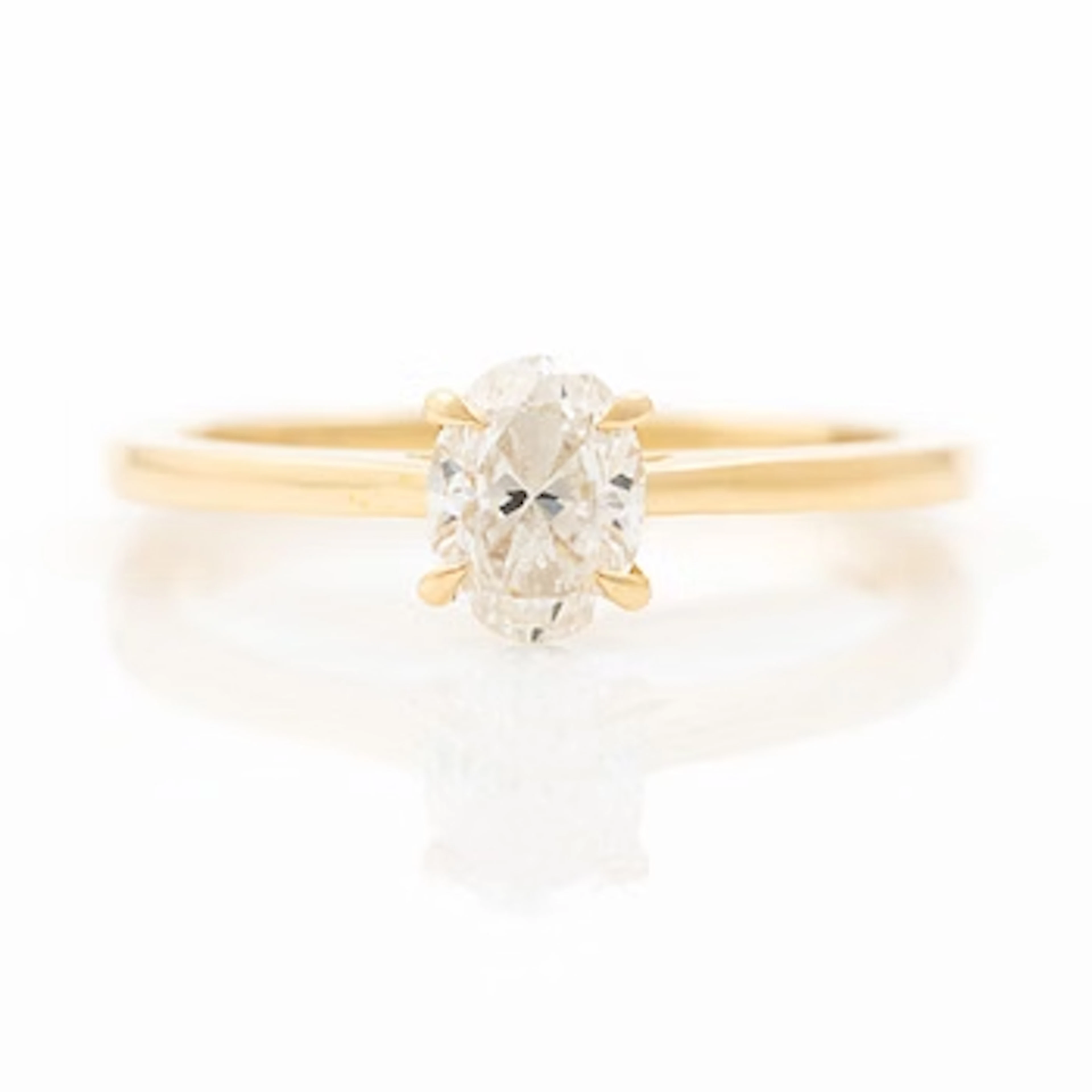 18K gold ring set with an oval-cut diamond weighing 0.72 ct, accompanied
