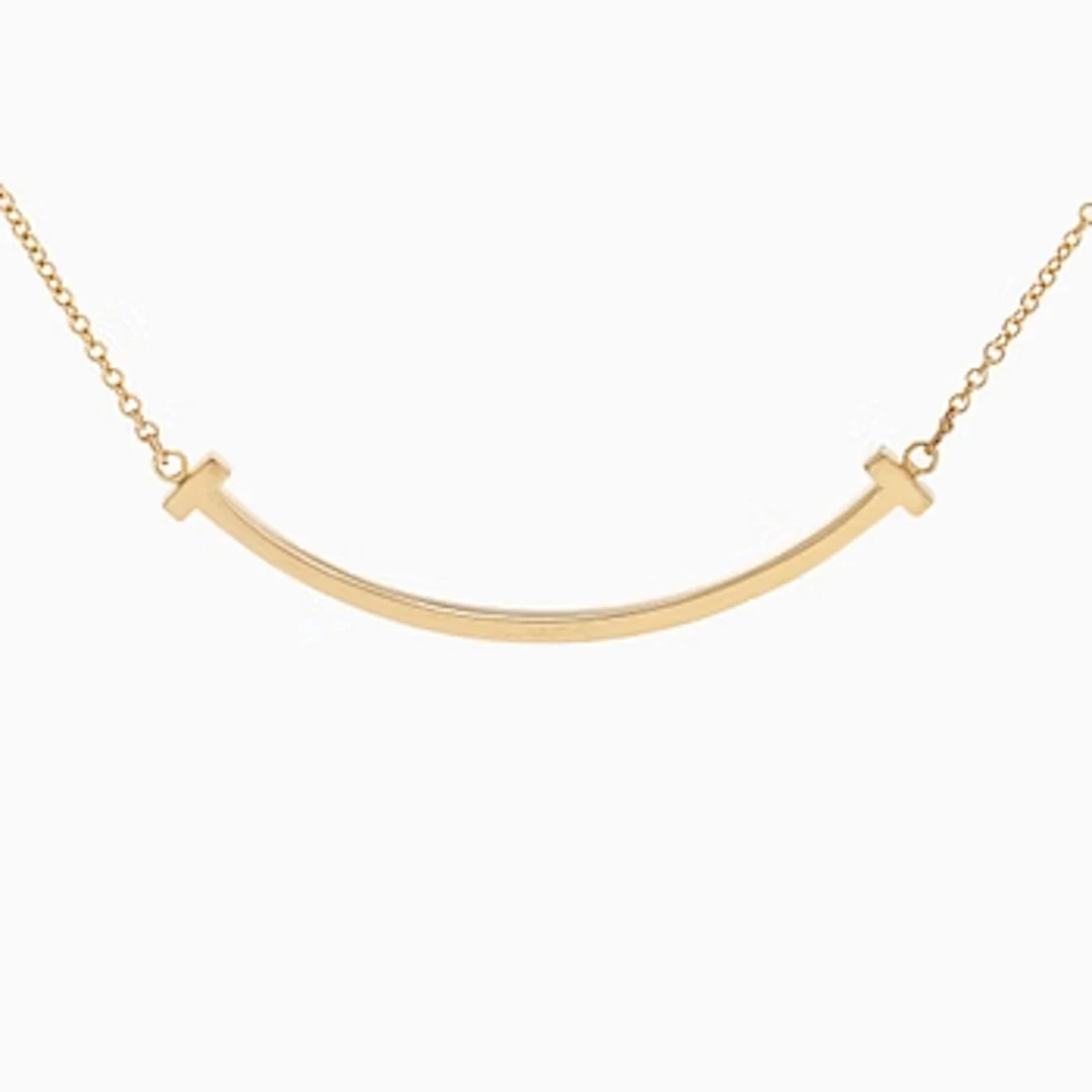 Tiffany & Co, an 18K gold 'T Smile' necklace.