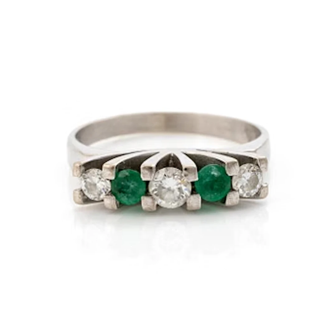18K white gold ring set with round brilliant-cut diamonds and emeralds.