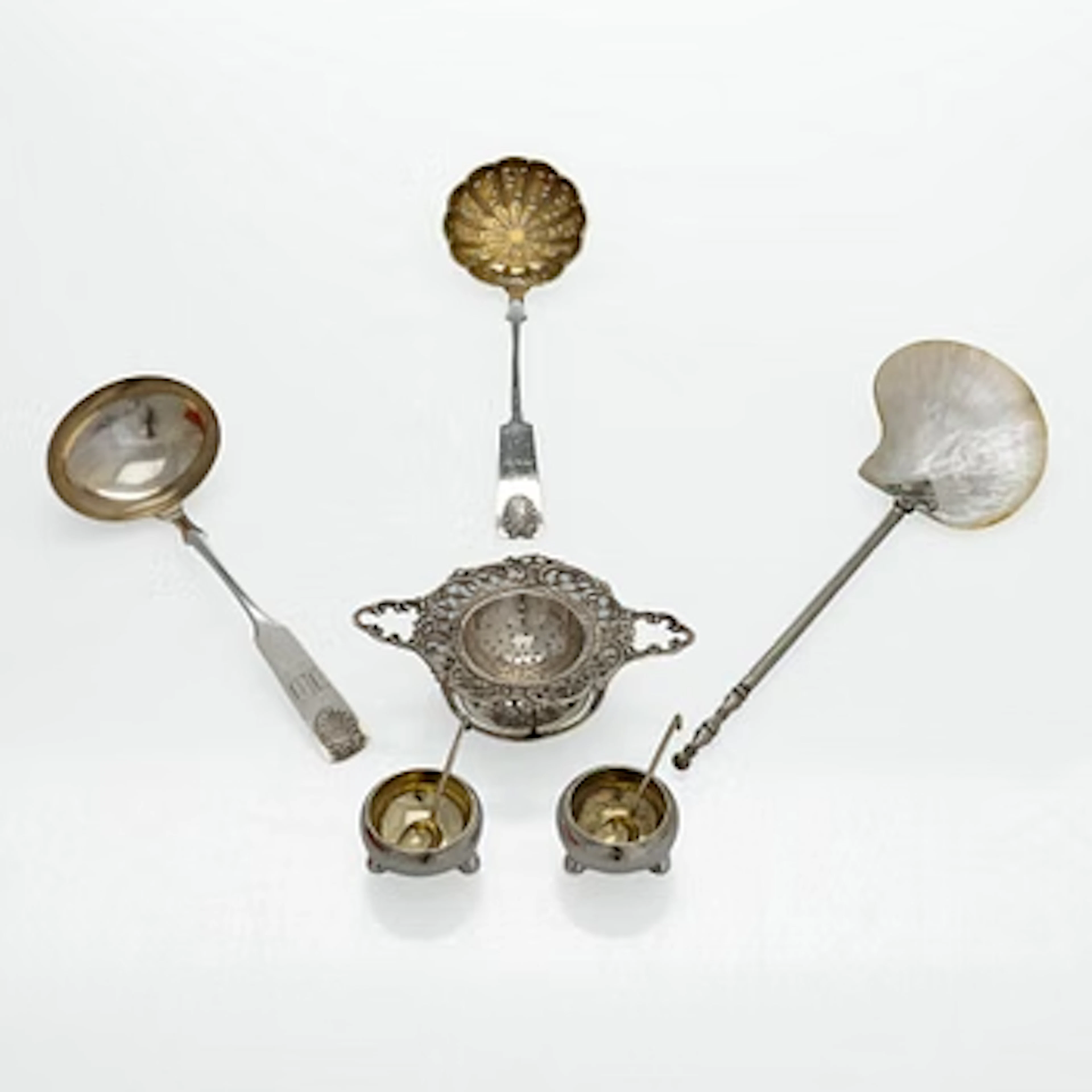 A pair of Russian silver salt cellars, a sprinkle spoon, a sauce ladle