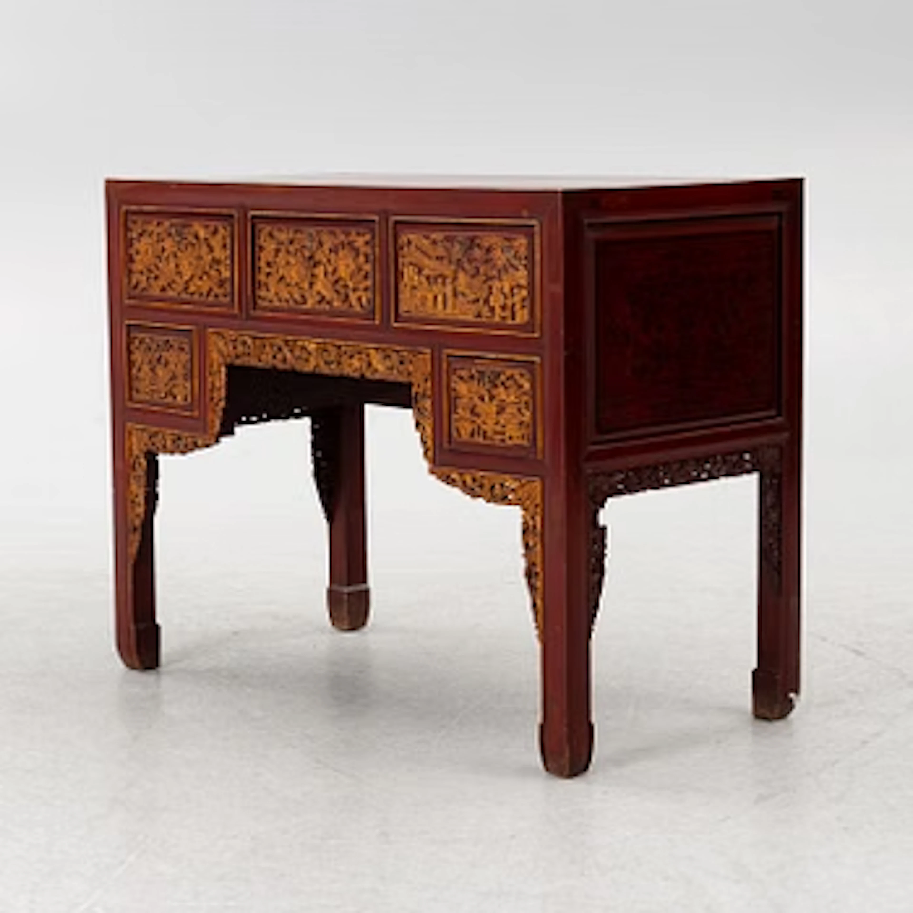 A red-lacquered desk, China, first half of the 20th century.