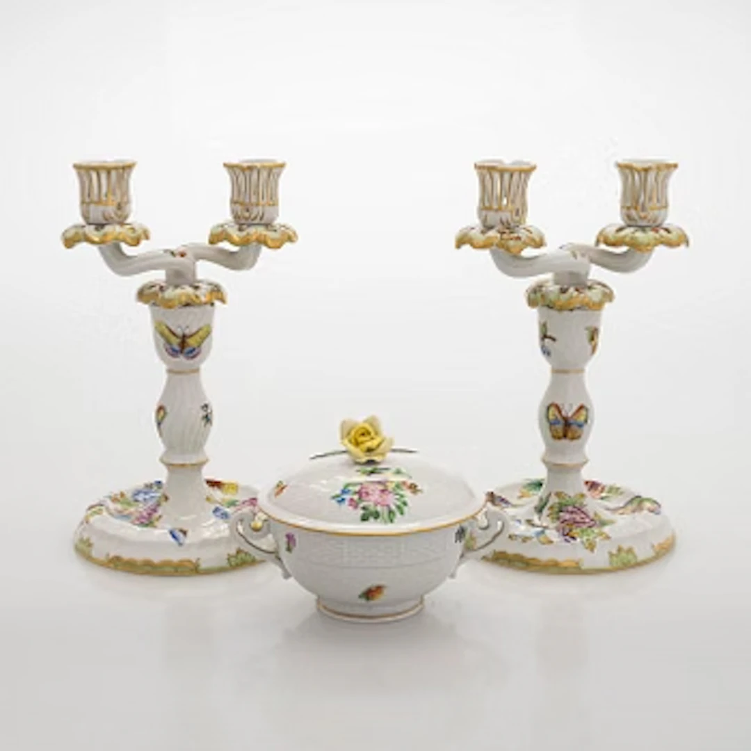 A pair of Herend porcelain candlesticks, and a lidded sugar bowl, Hungary.