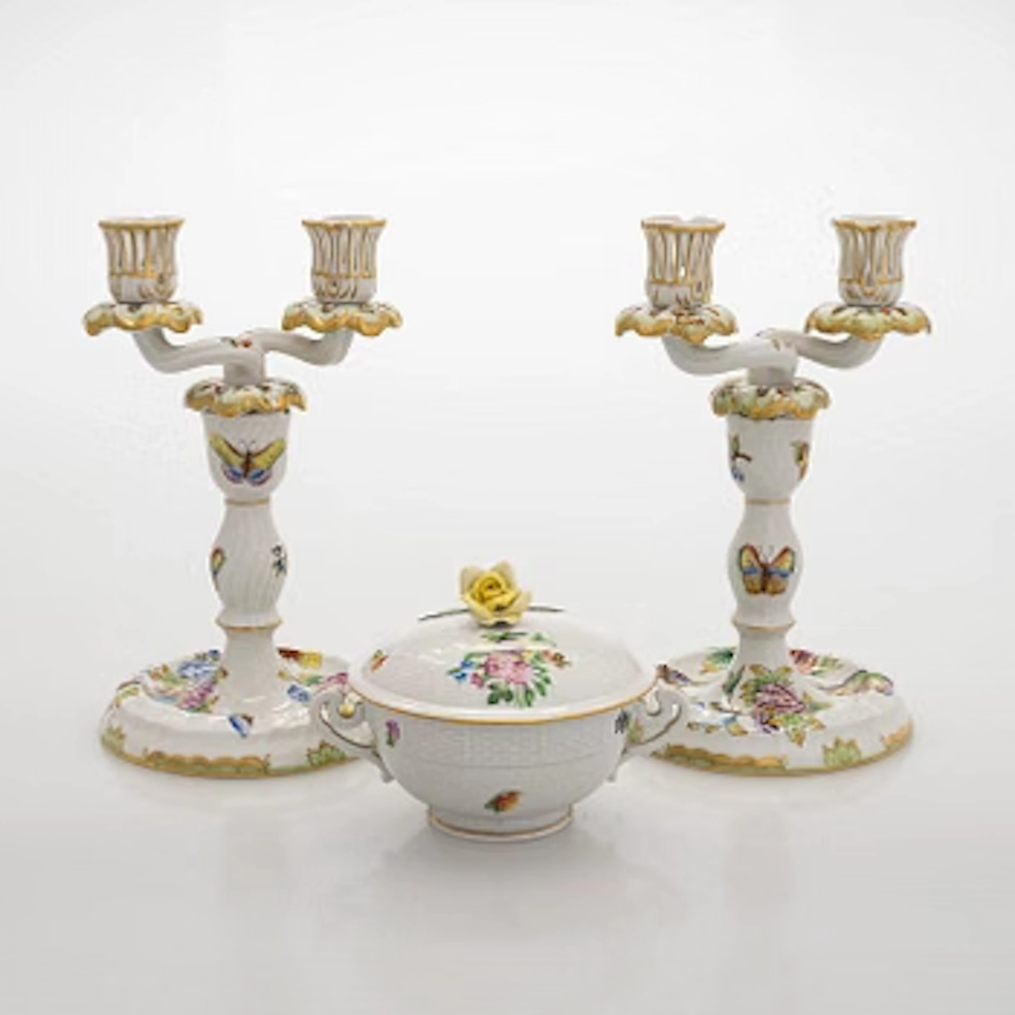 A pair of Herend porcelain candlesticks, and a lidded sugar bowl, Hungary.