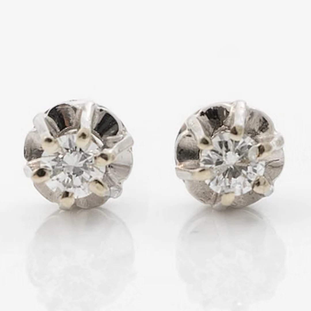 A pair of 18K white gold earrings with round brilliant-cut diamonds.