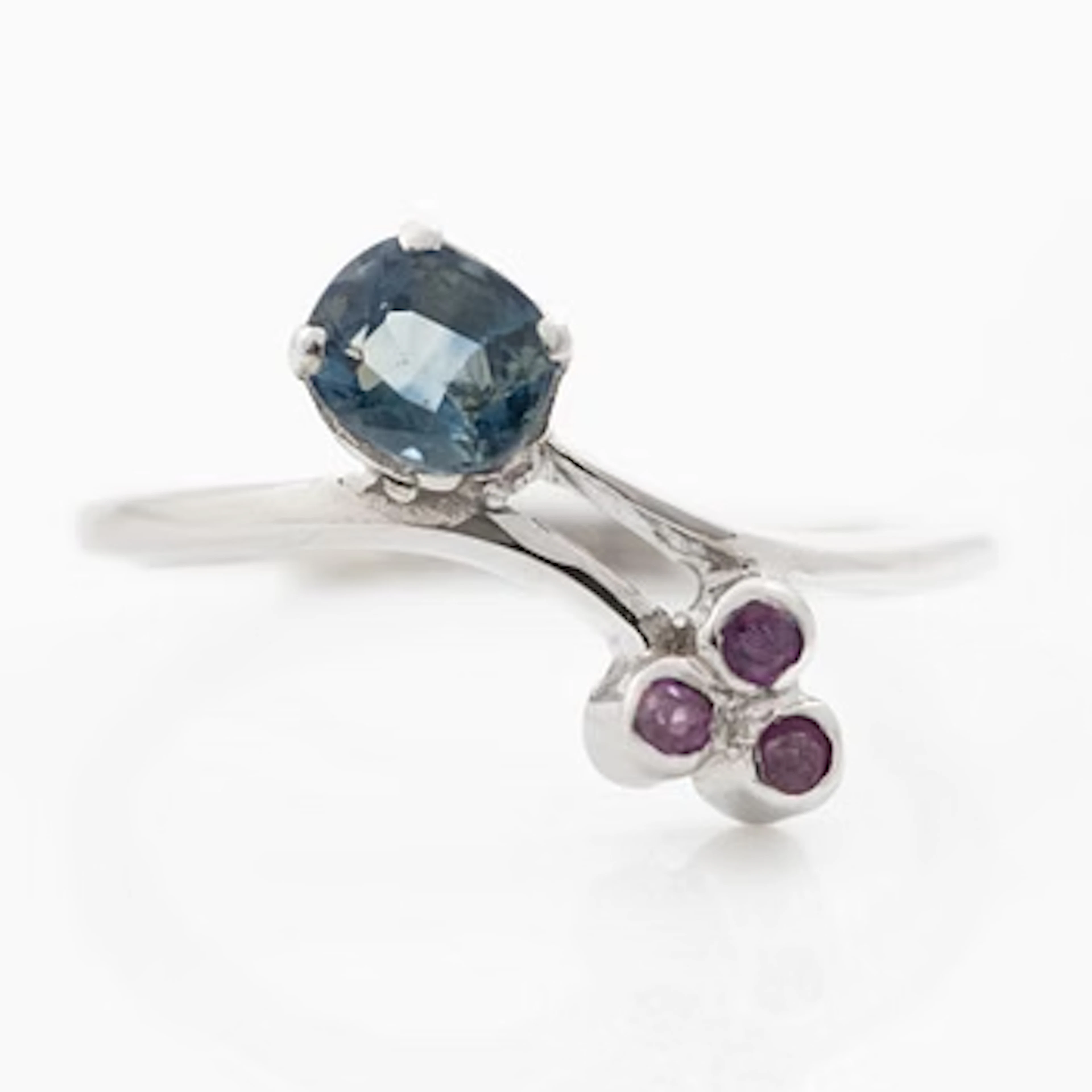 14K white gold ring with sapphire and small rubies.