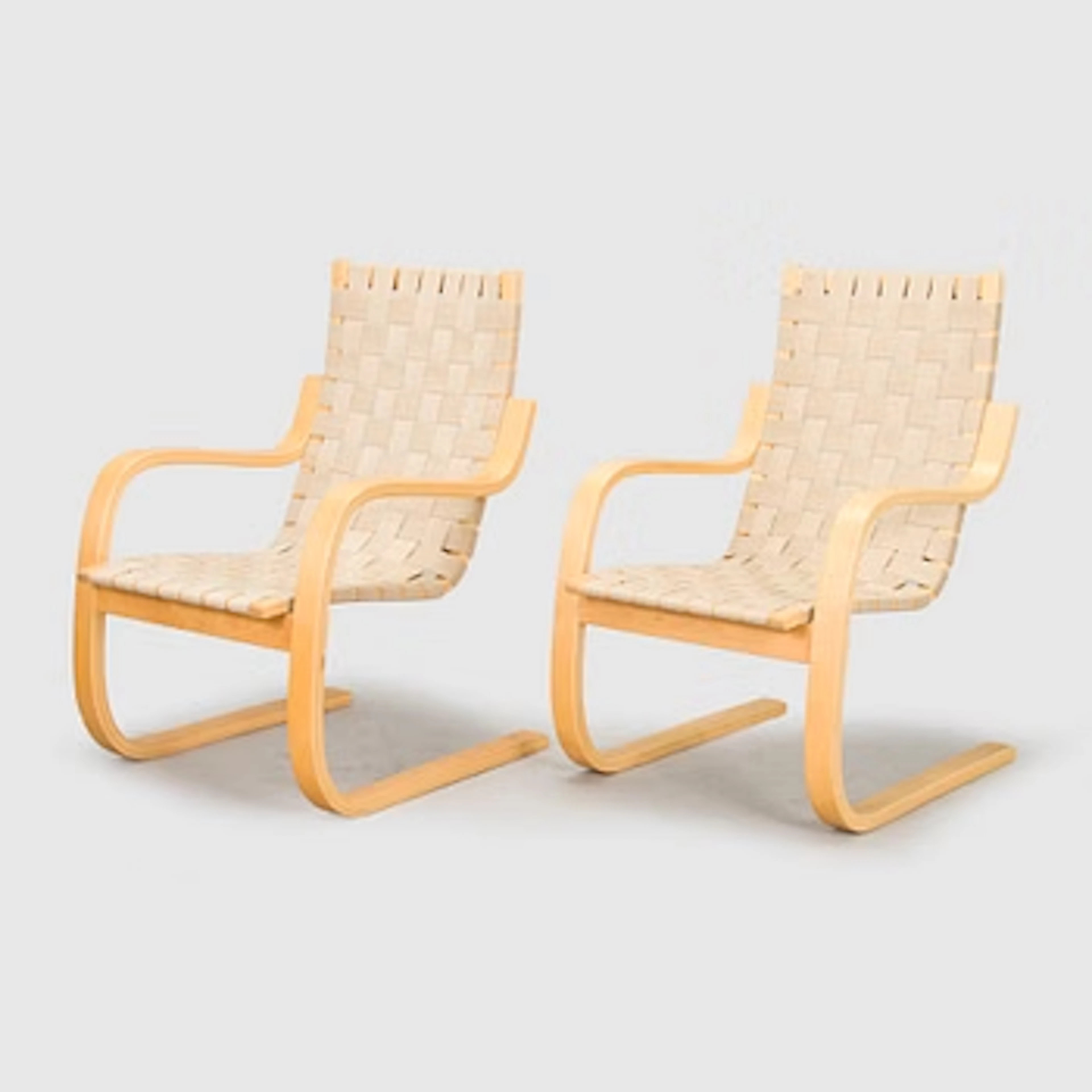 Alvar Aalto, a pair of late 20th century armchairs, model 406 for Artek.