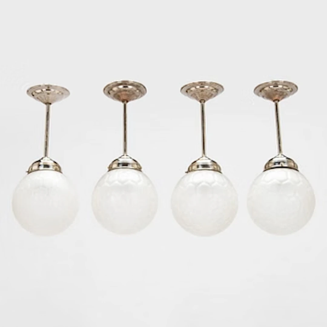 Four early 20th century pendant lights.