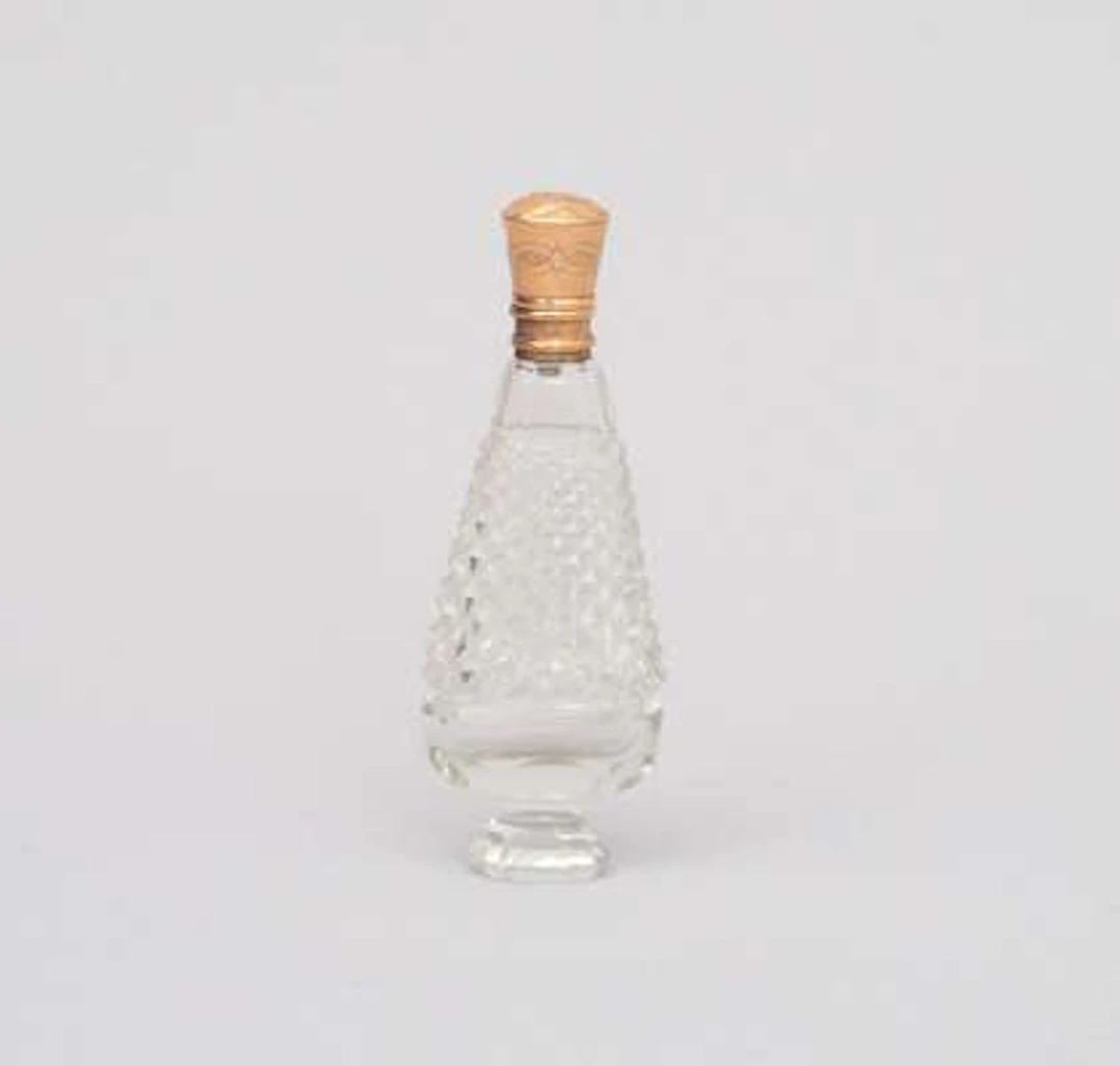 An antique crystal perfume bottle with 14k yellow gold cap. Holland ca. 1900.
