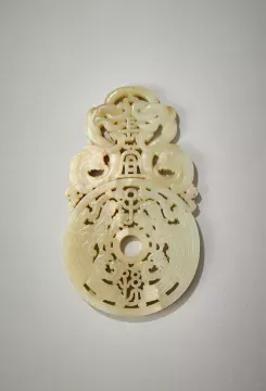 A Chinese pale celadon and white jade plaque