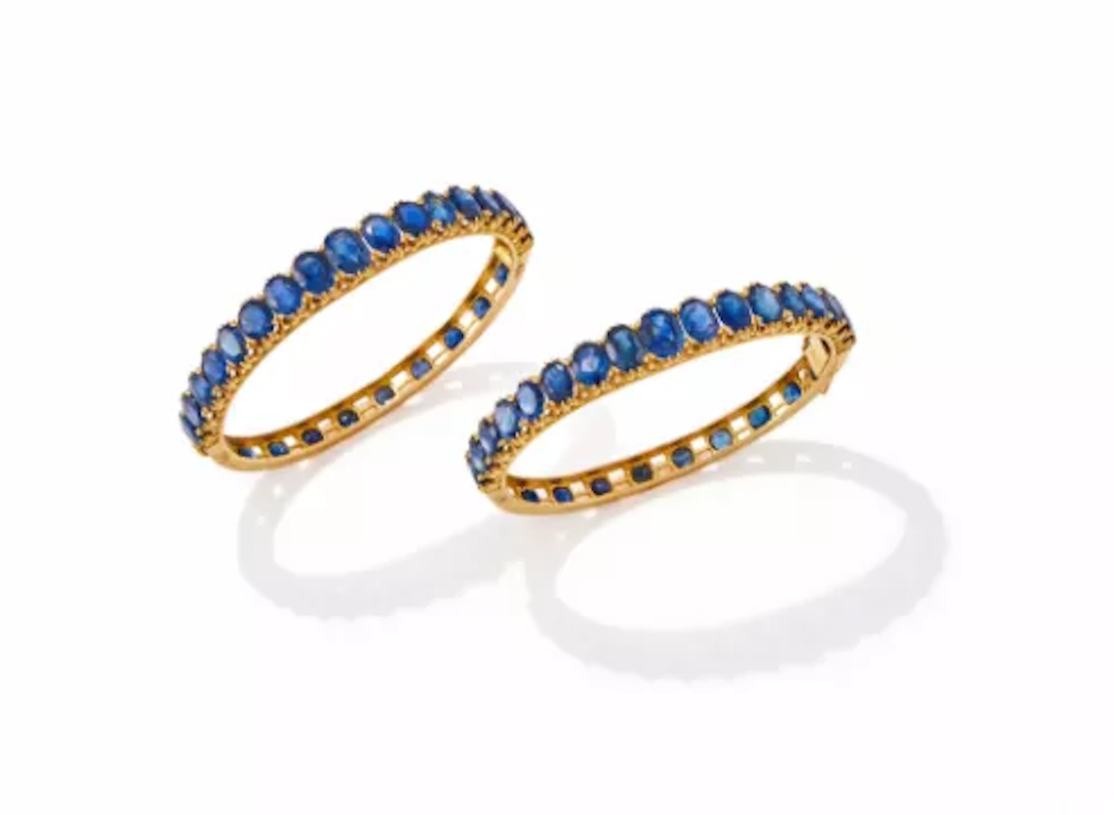 A PAIR OF SAPPHIRE SET HINGED BANGLES